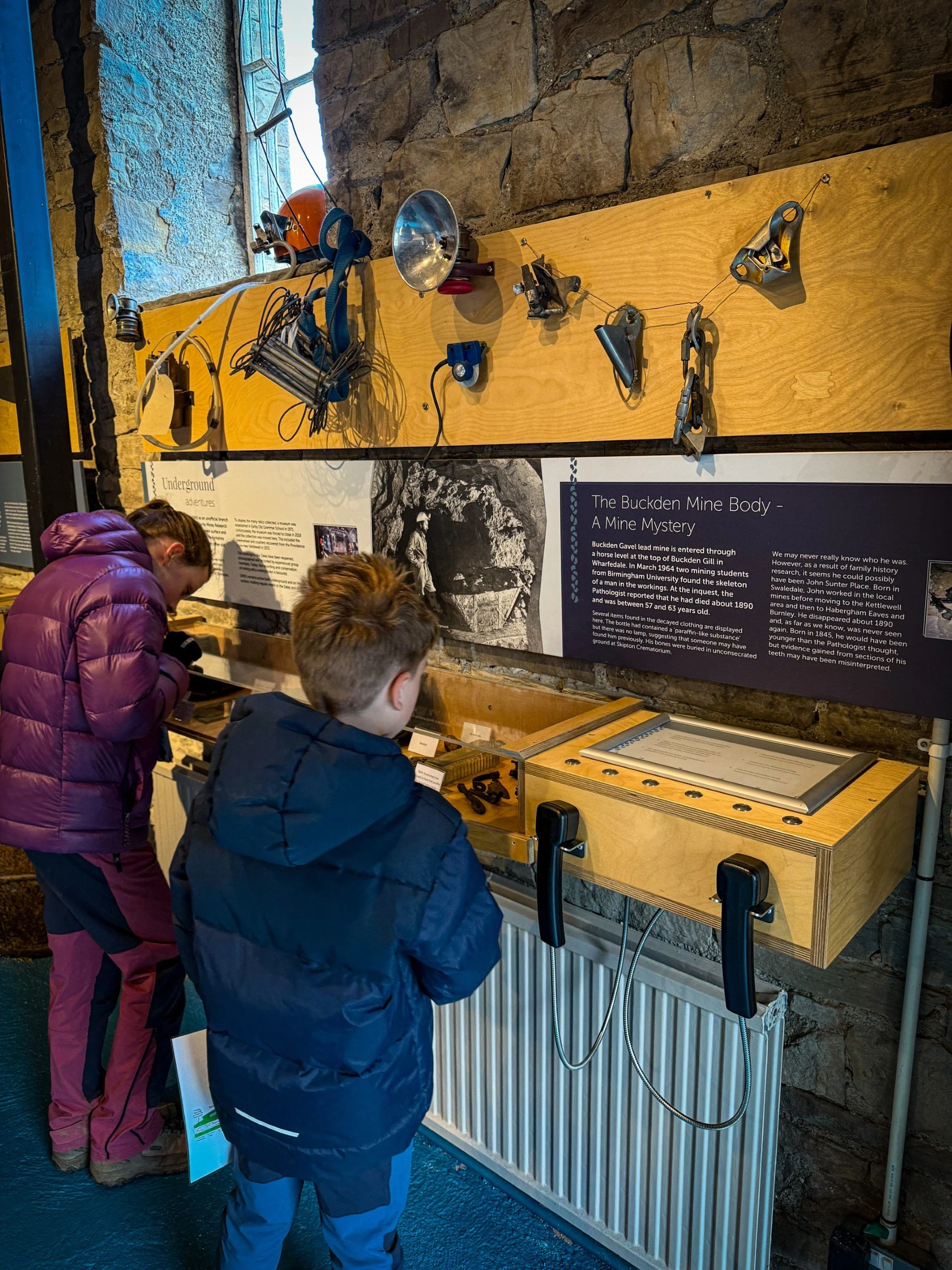 Children in a museum looking at an exhibit about a mining mystery