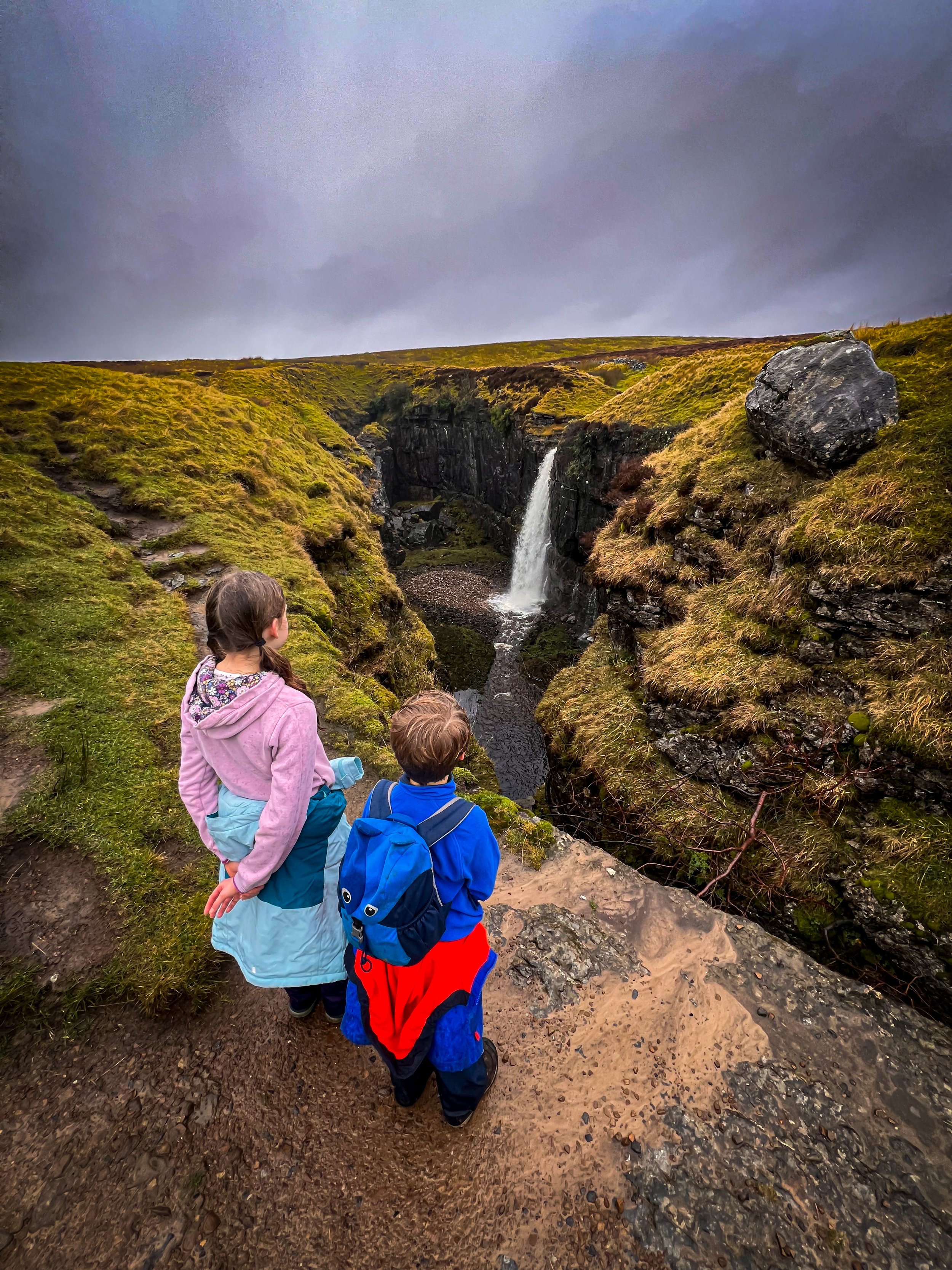 The occasional waterfall on the side of Pen y ghent at Hull Pot flowing into huge chasm