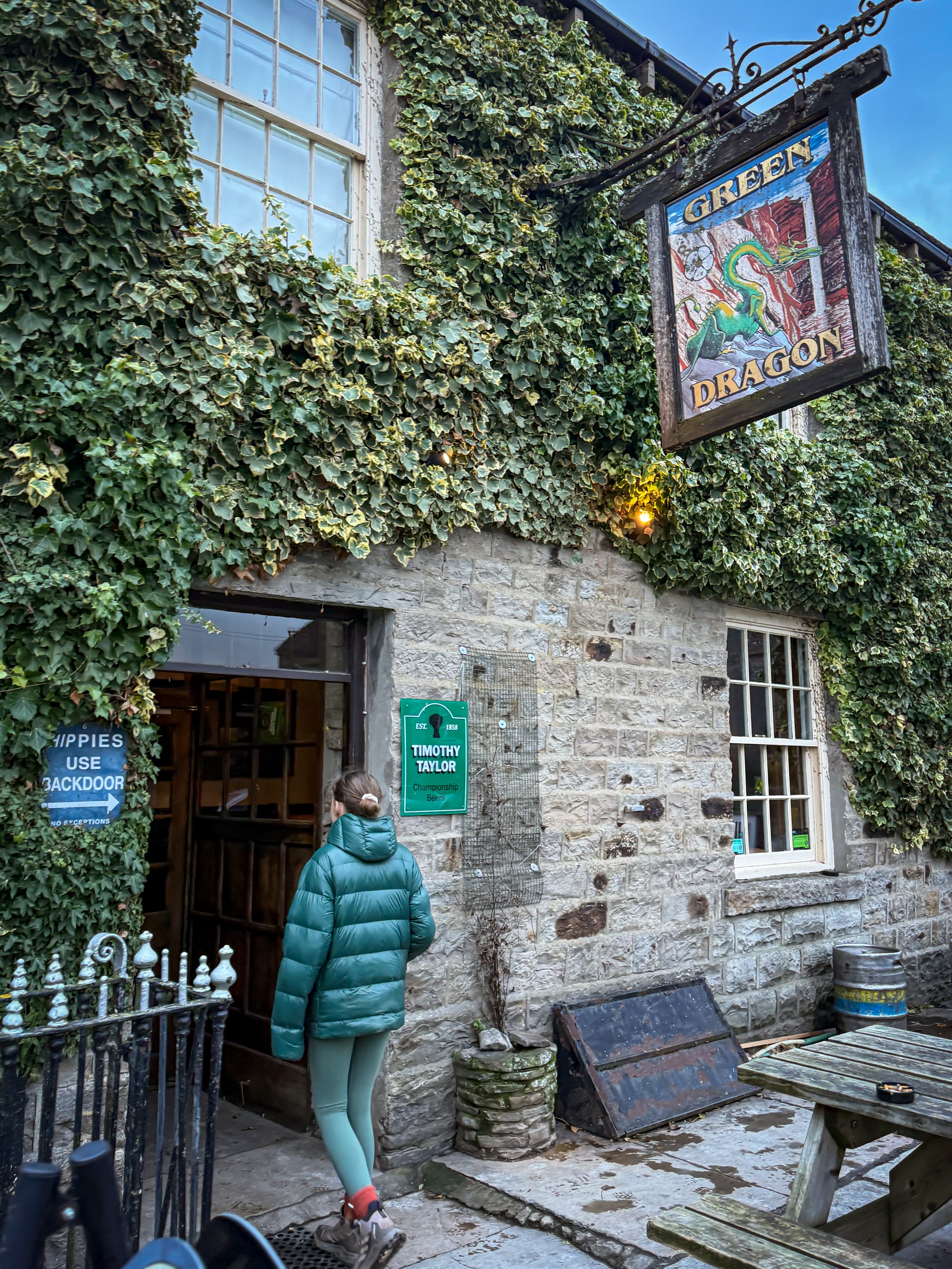 Walking into the The Green Dragon pub door at Hardraw with ivy covering the building
