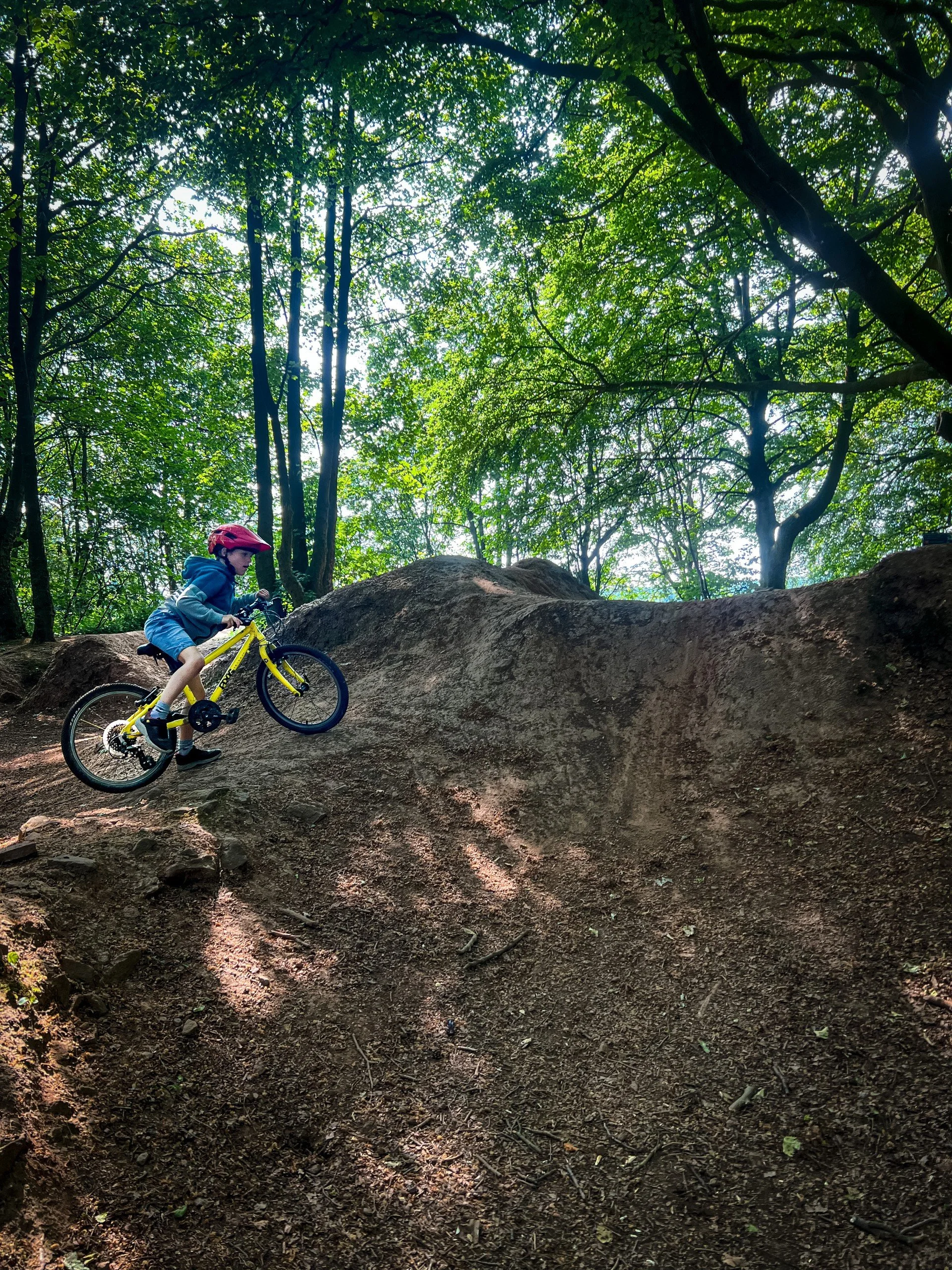 Child riding a bike on a dirt track