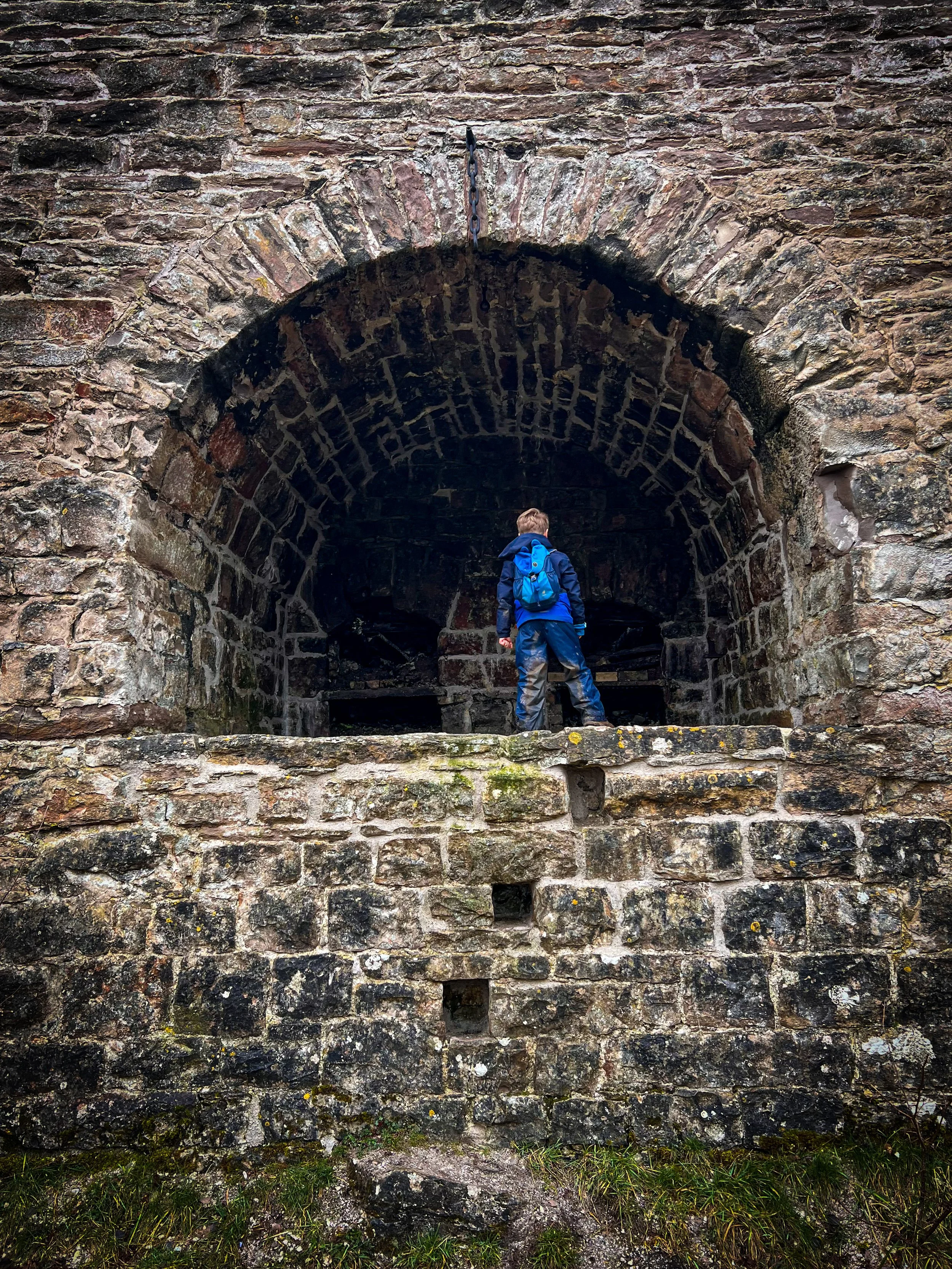 Child standing in the remains of an old stone lime kiln