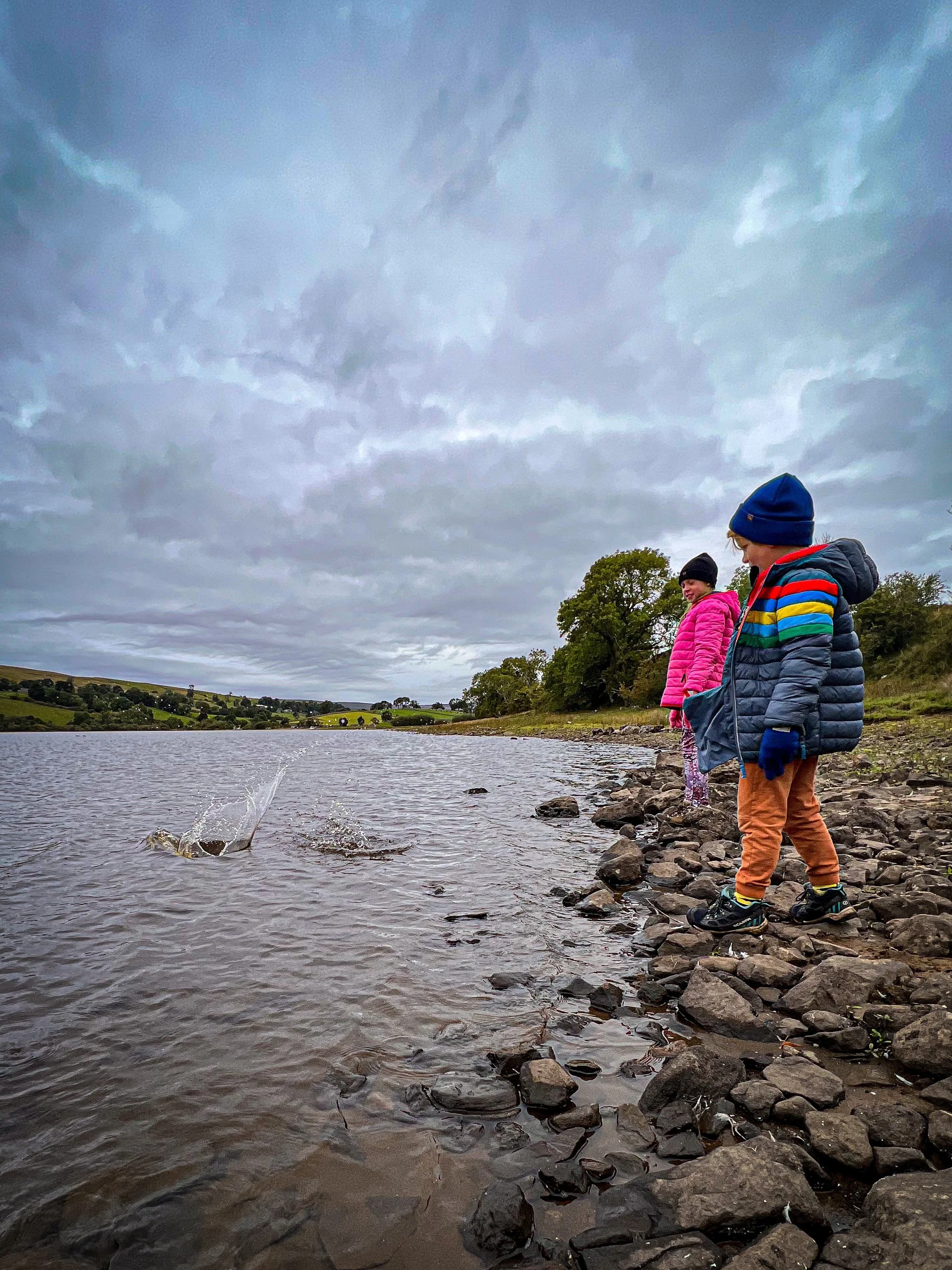 Children throwing stones into the Lake
