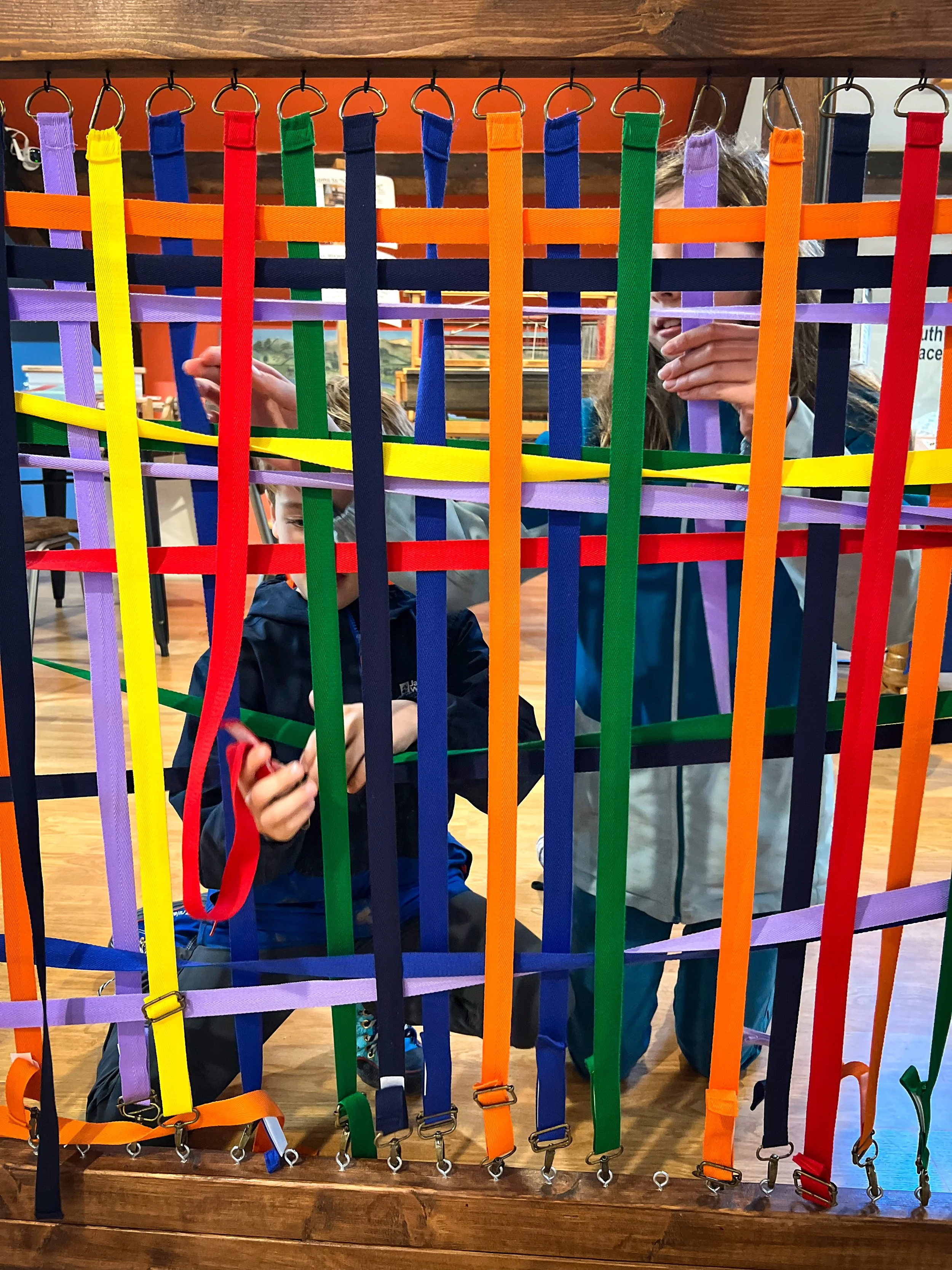 Child weaving using multicoloured ribbon