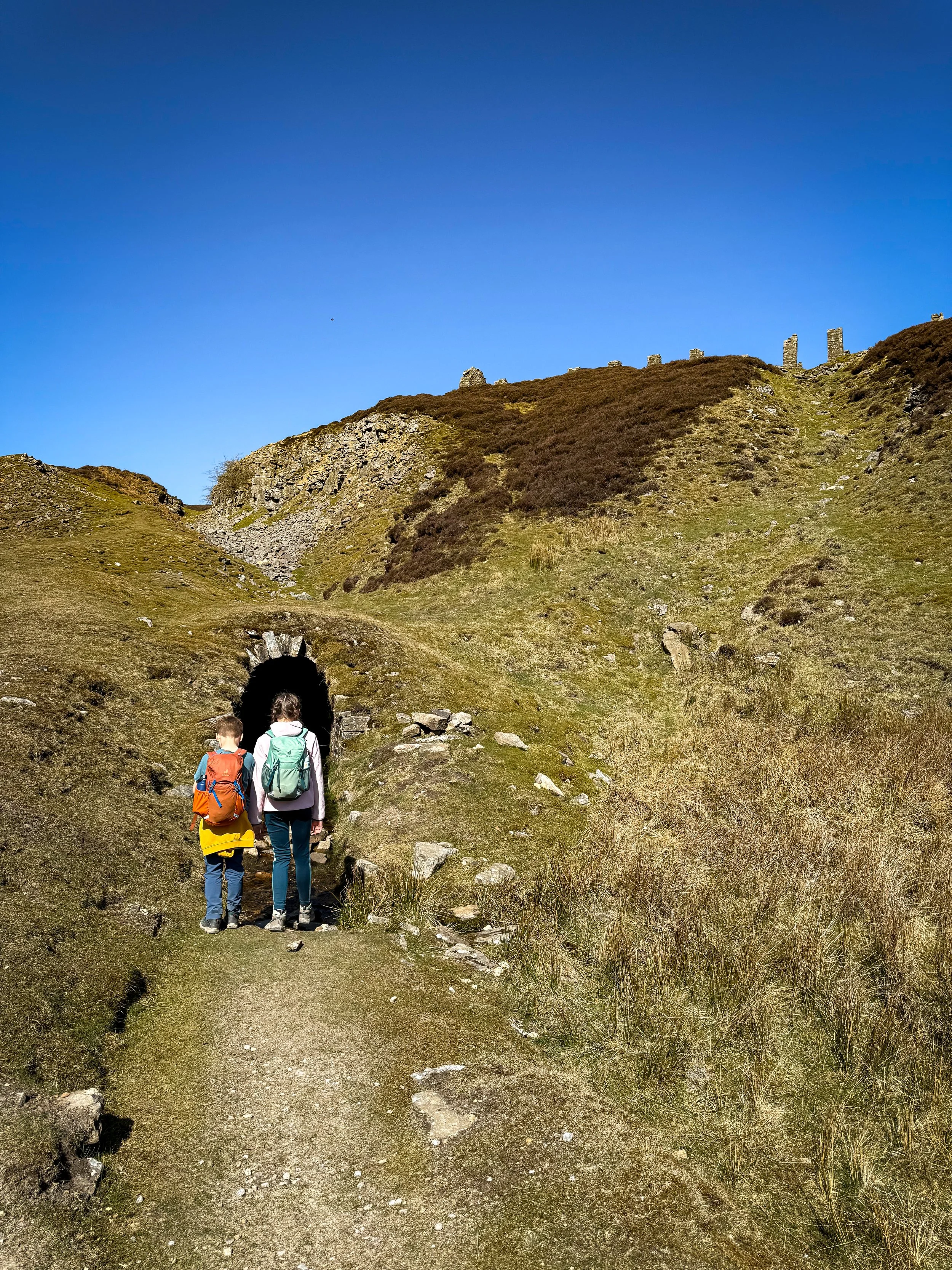 Children standing at the entrance to a mine tunnel