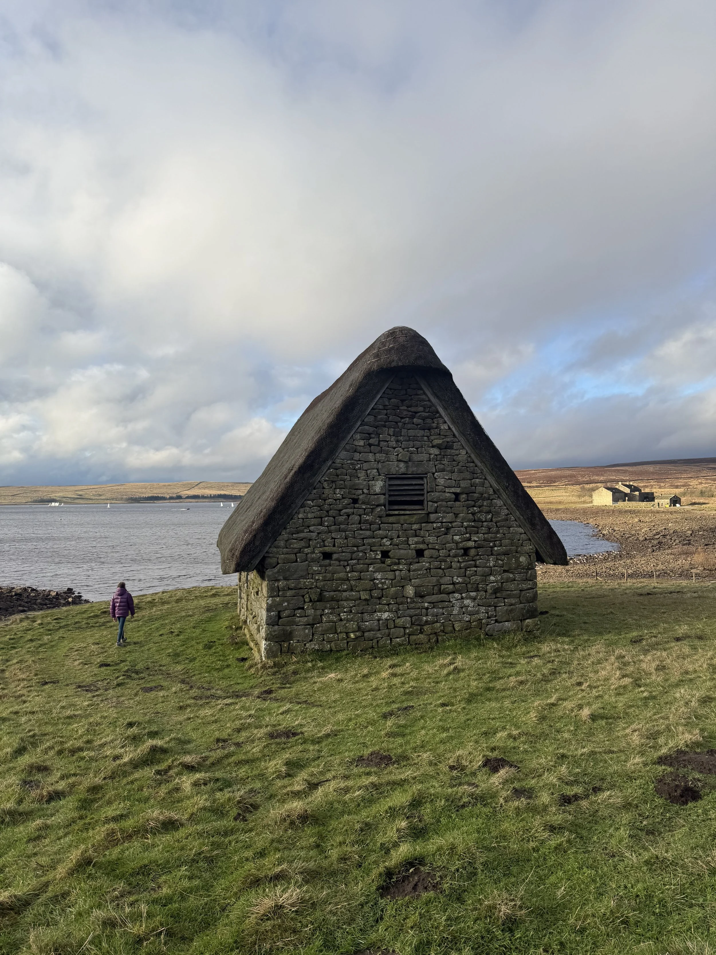 A little building with a child next to it