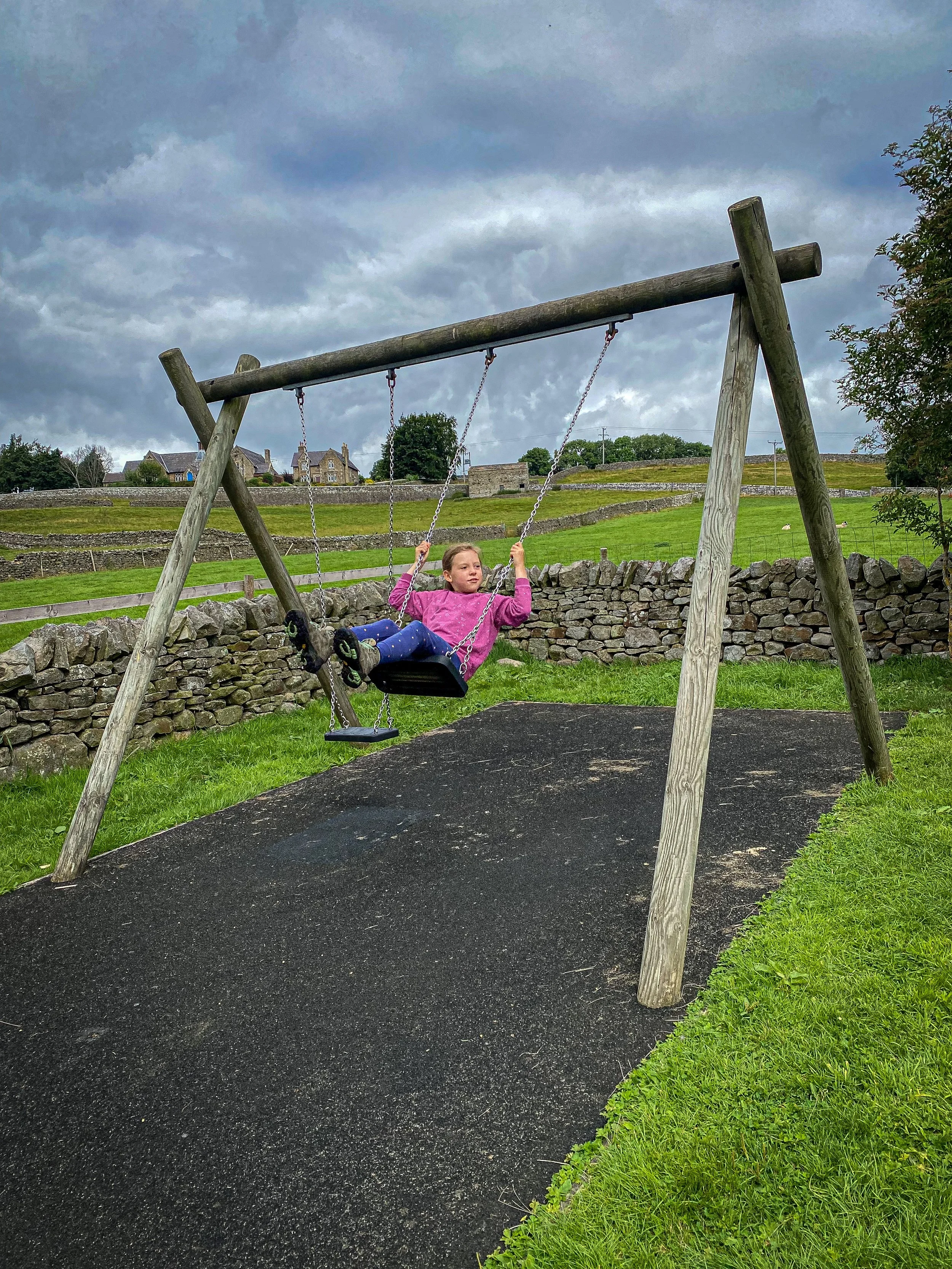 swinging on the swing at Reeth Play Park