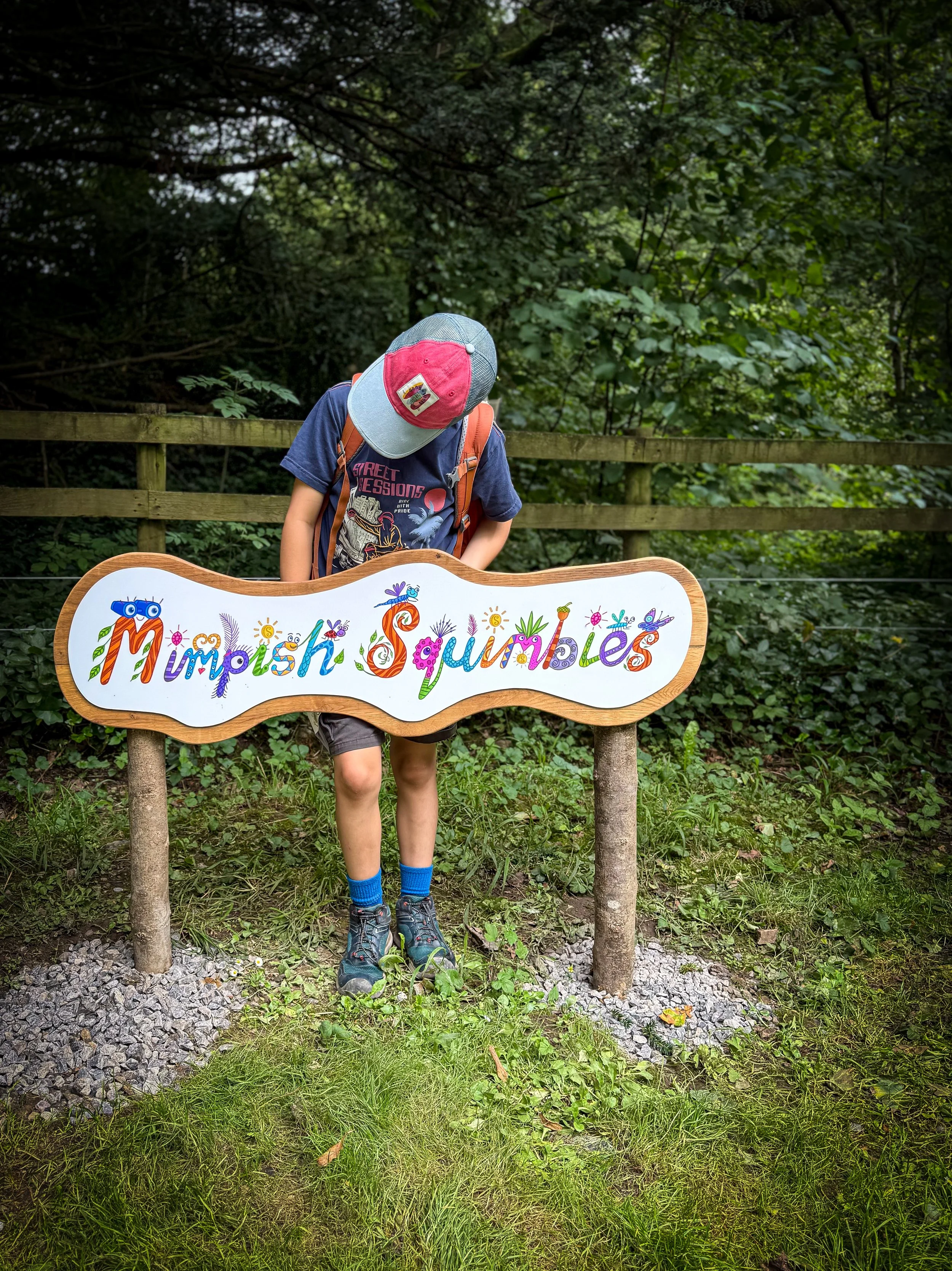 a child standing at the mimpish squimbies sign