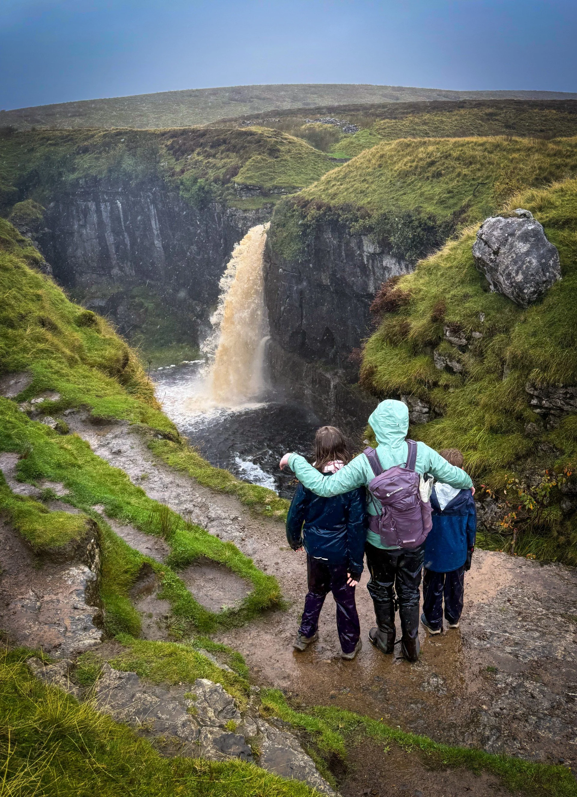 Hull pot collapsed cave with waterfall flowing into  it