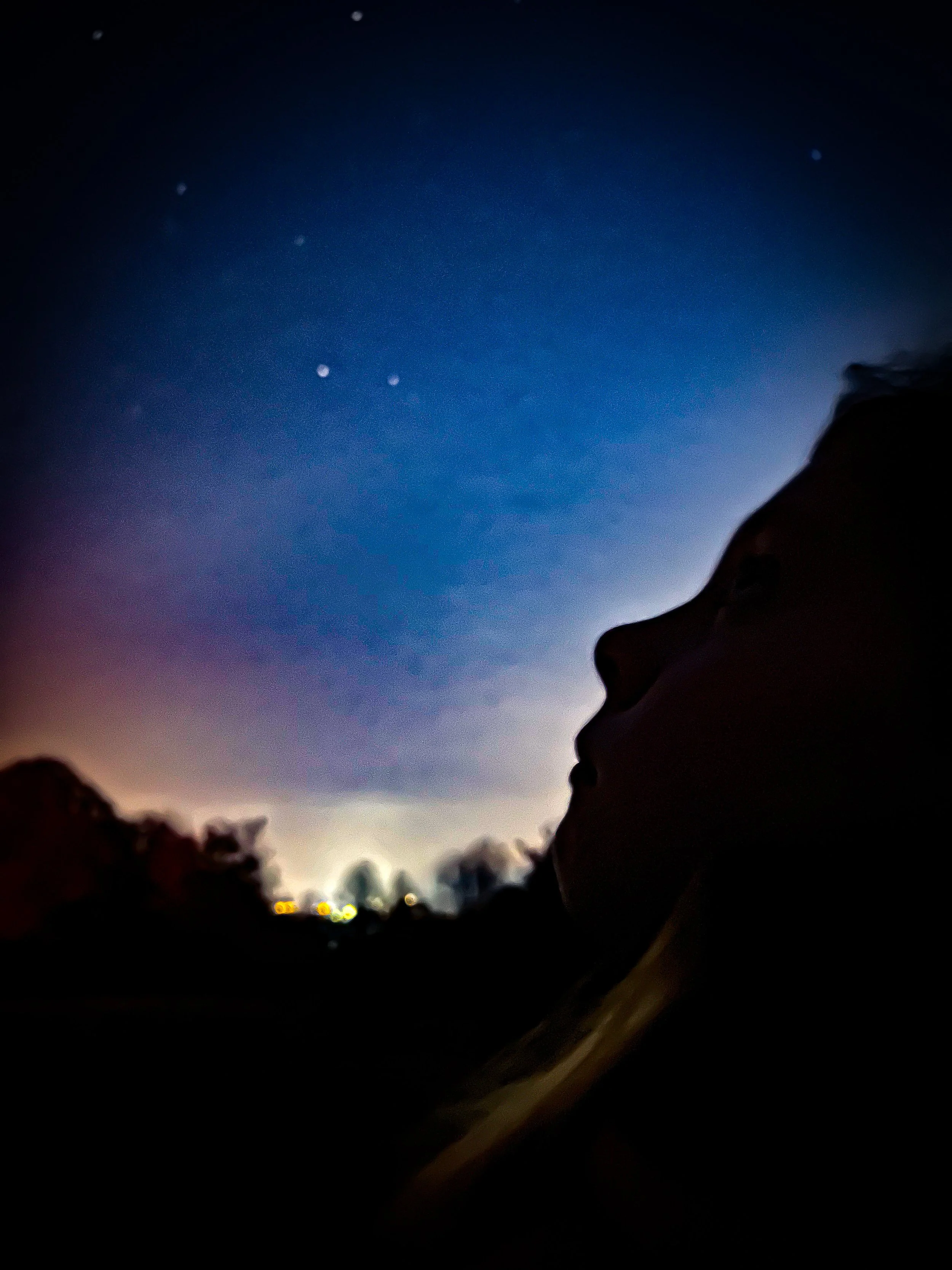 Child's profile looking up at starry sky