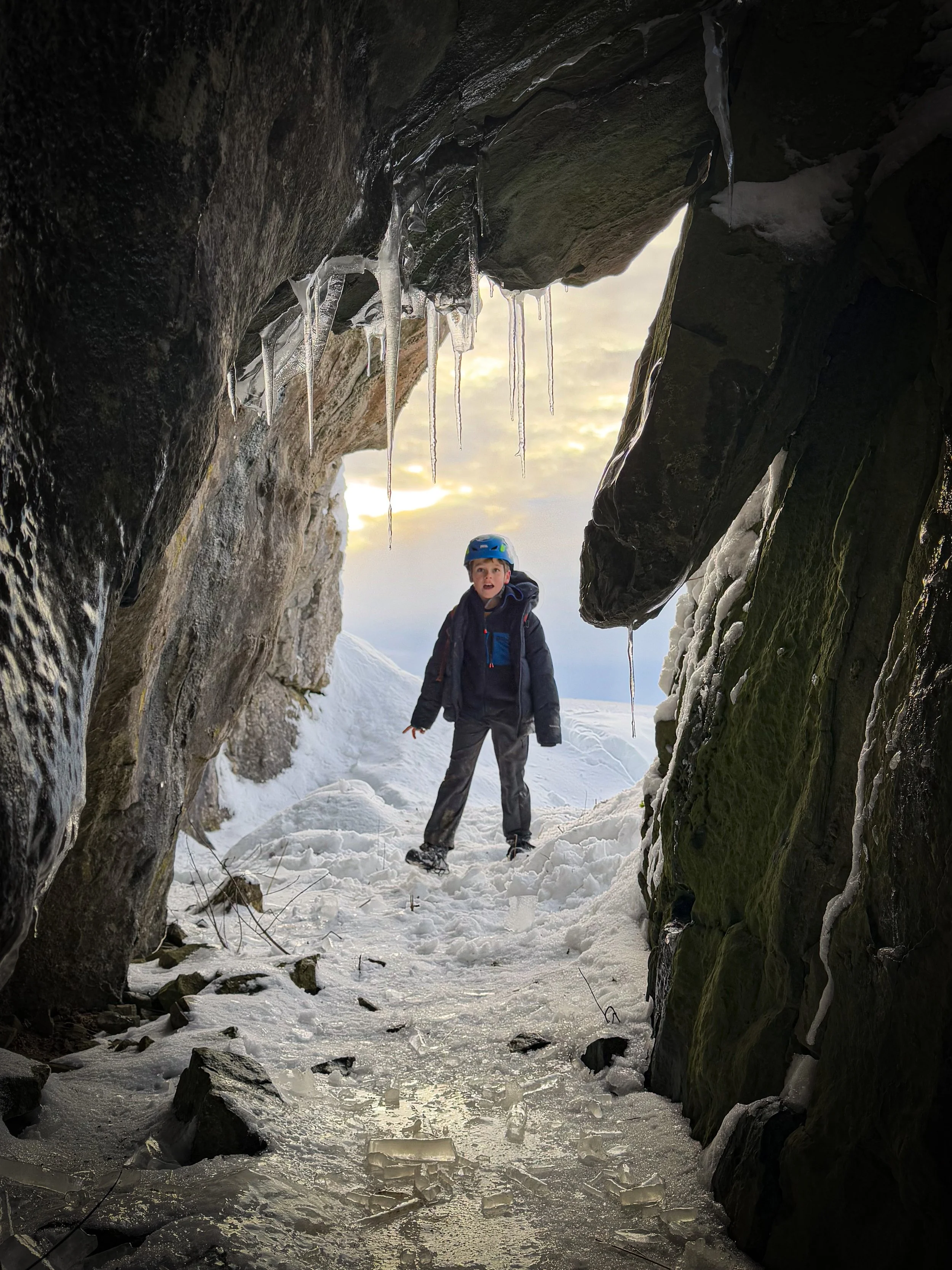 Child walking in helmet with icicles and snow conditions