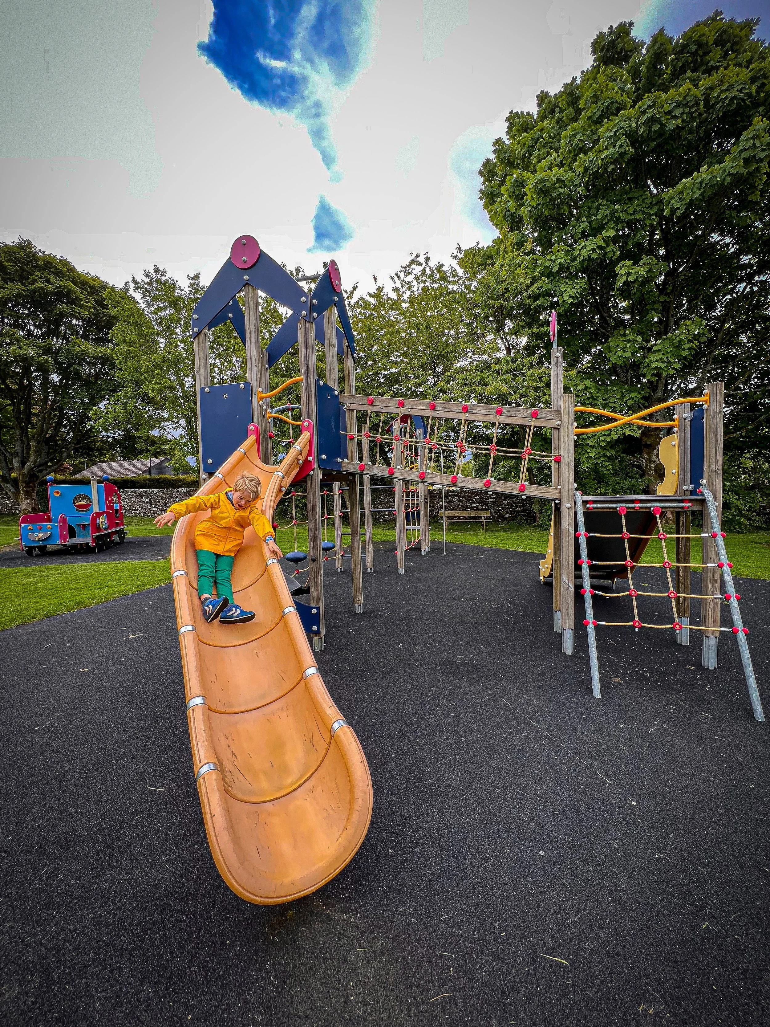 Sliding down the side at Grassington play park