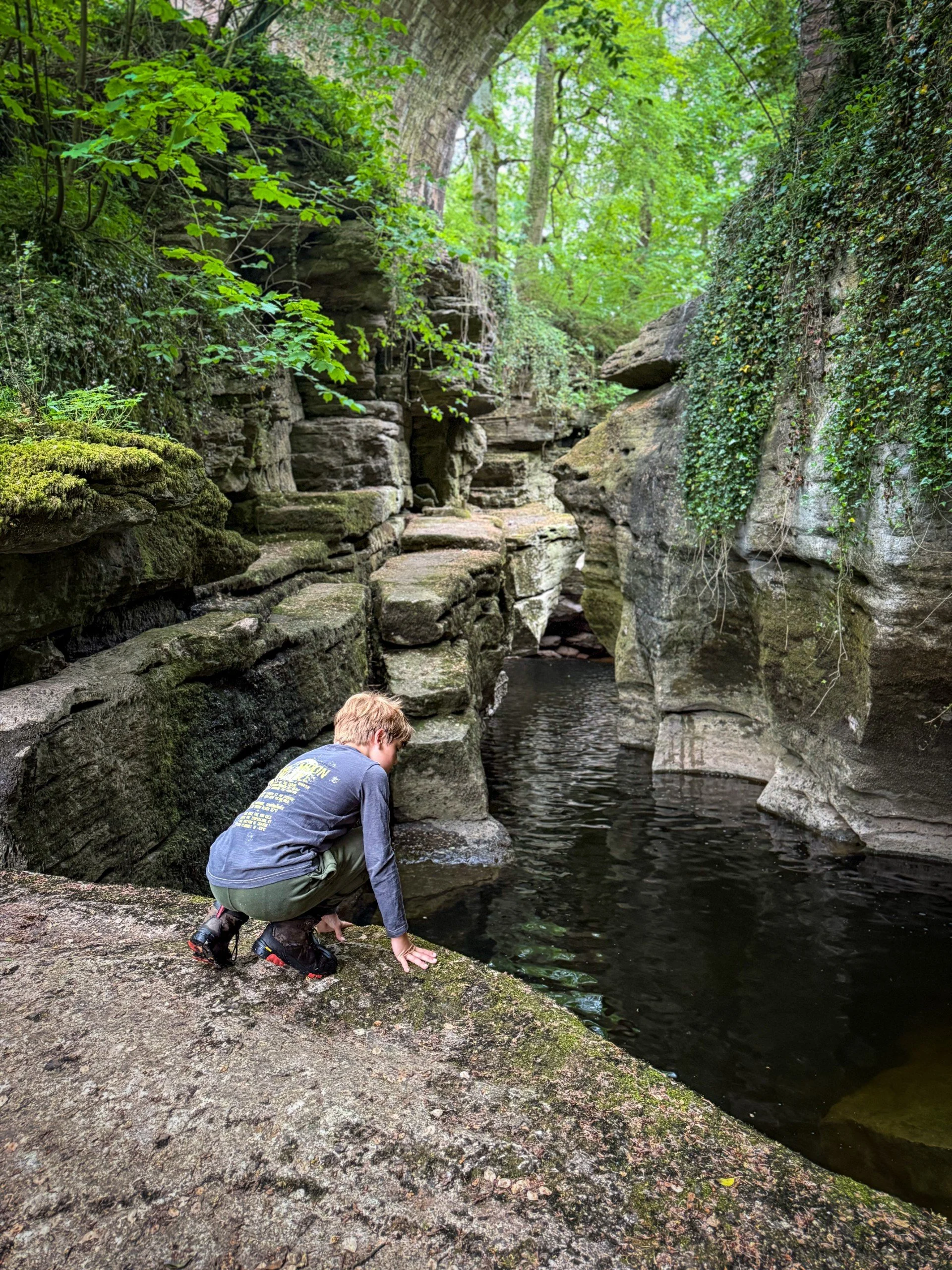 Child looking down at the water from a gorge