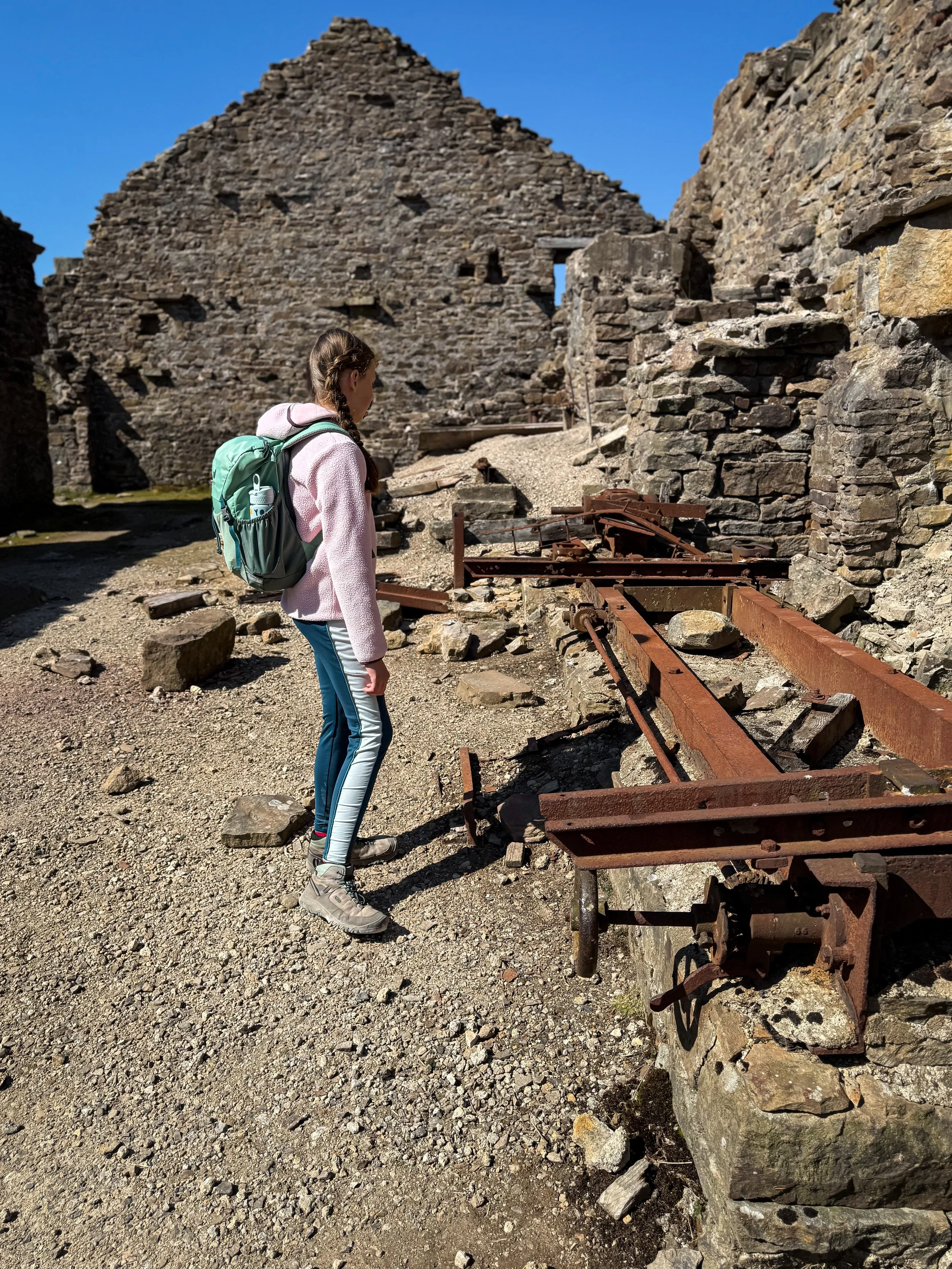 Child looking at ruins of machinery