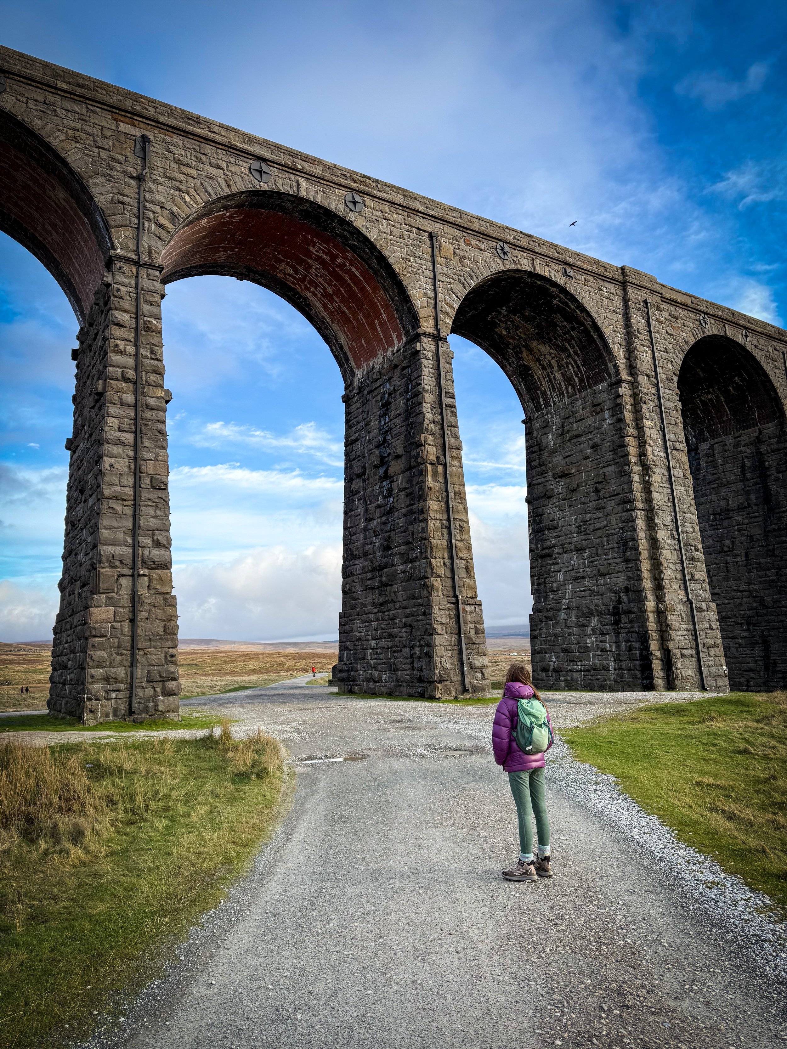 Child looking up at Ribblehead Viaduct