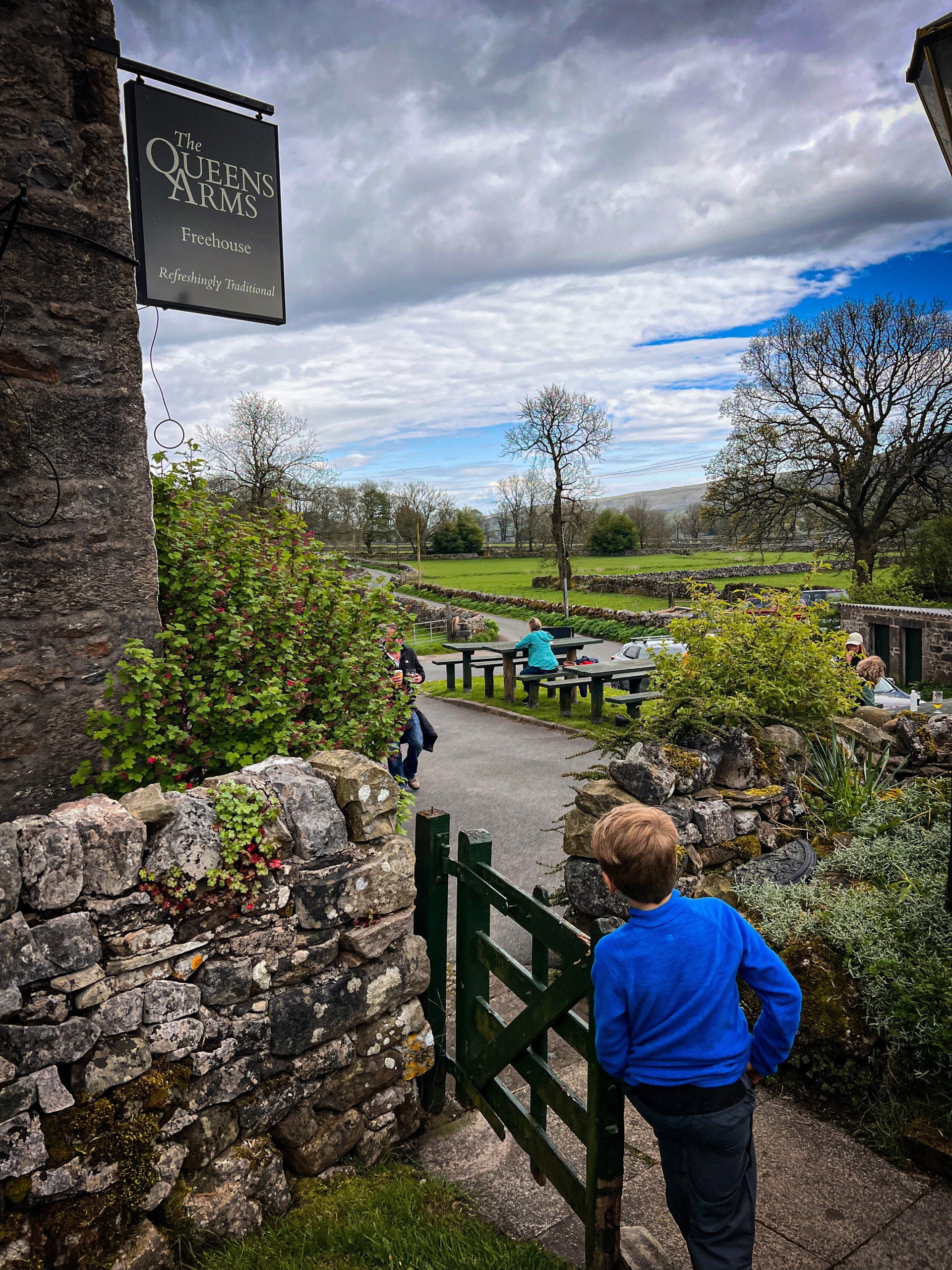 Child walking out of pub beer garden
