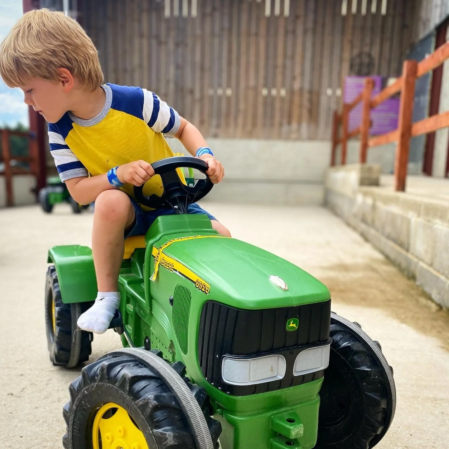 Child sitting on a ride on tractor