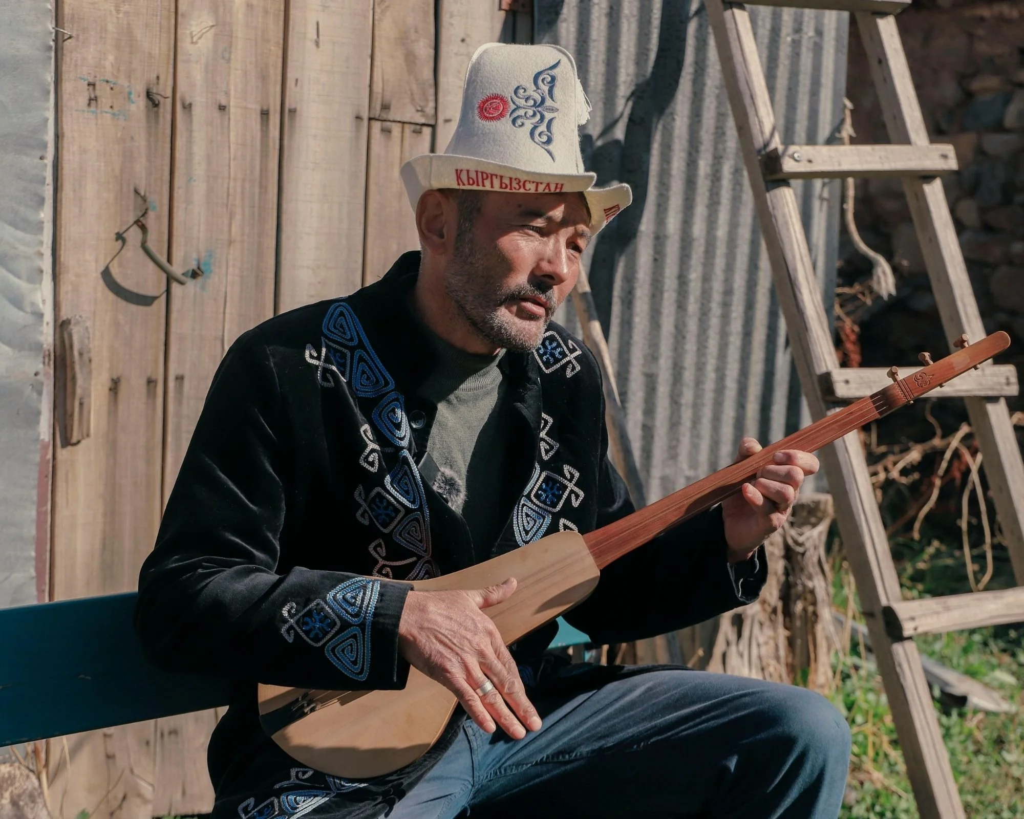 Man_Playing_Traditional_Komuz_String Instrument_Kyrgyzstan.jpg
