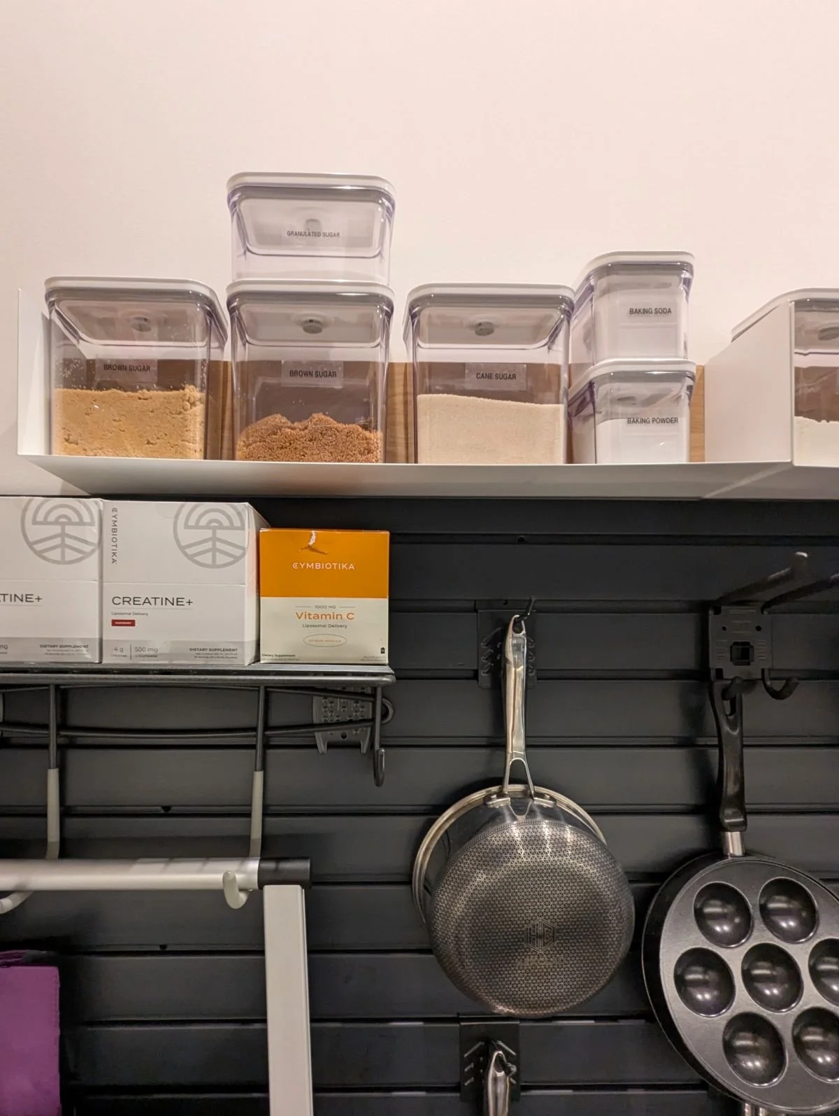 Pantry shelves organized with clear containers and labeled dry goods