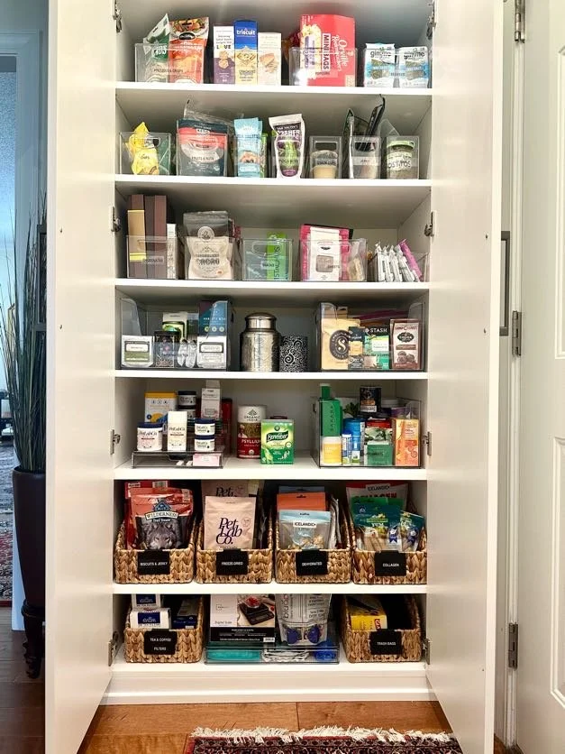 Organized overflow pantry with labeled bins and shelves for food storage by Green Mountain Space NC