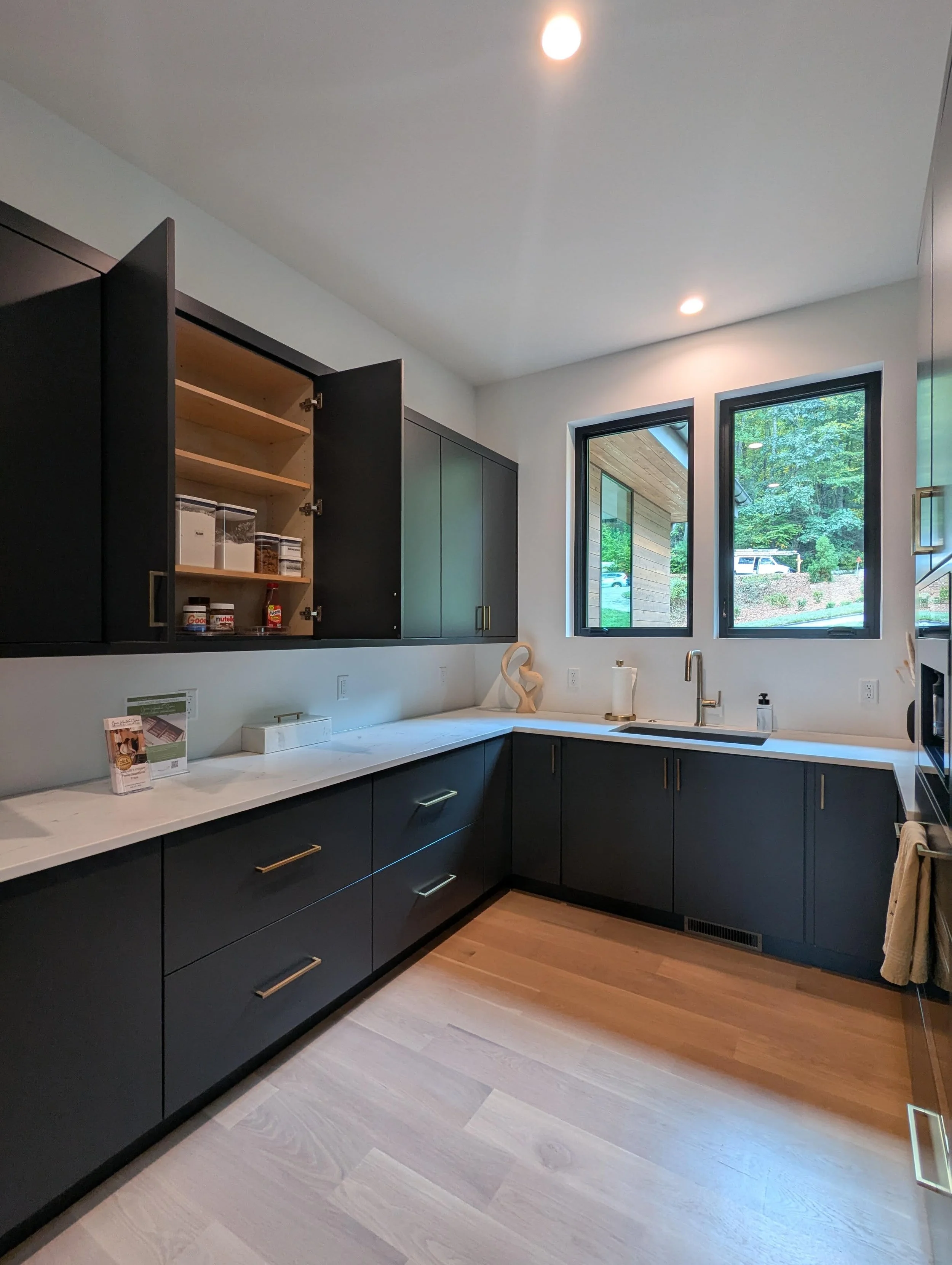 Decluttered kitchen cabinets staged for home sale by Green Mountain Space North Carolina