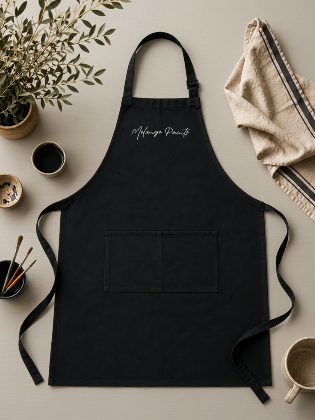 Mélange Paints Studio Apron in durable cotton canvas with utility pockets, designed for furniture painting, DIY projects, and creative studio work.