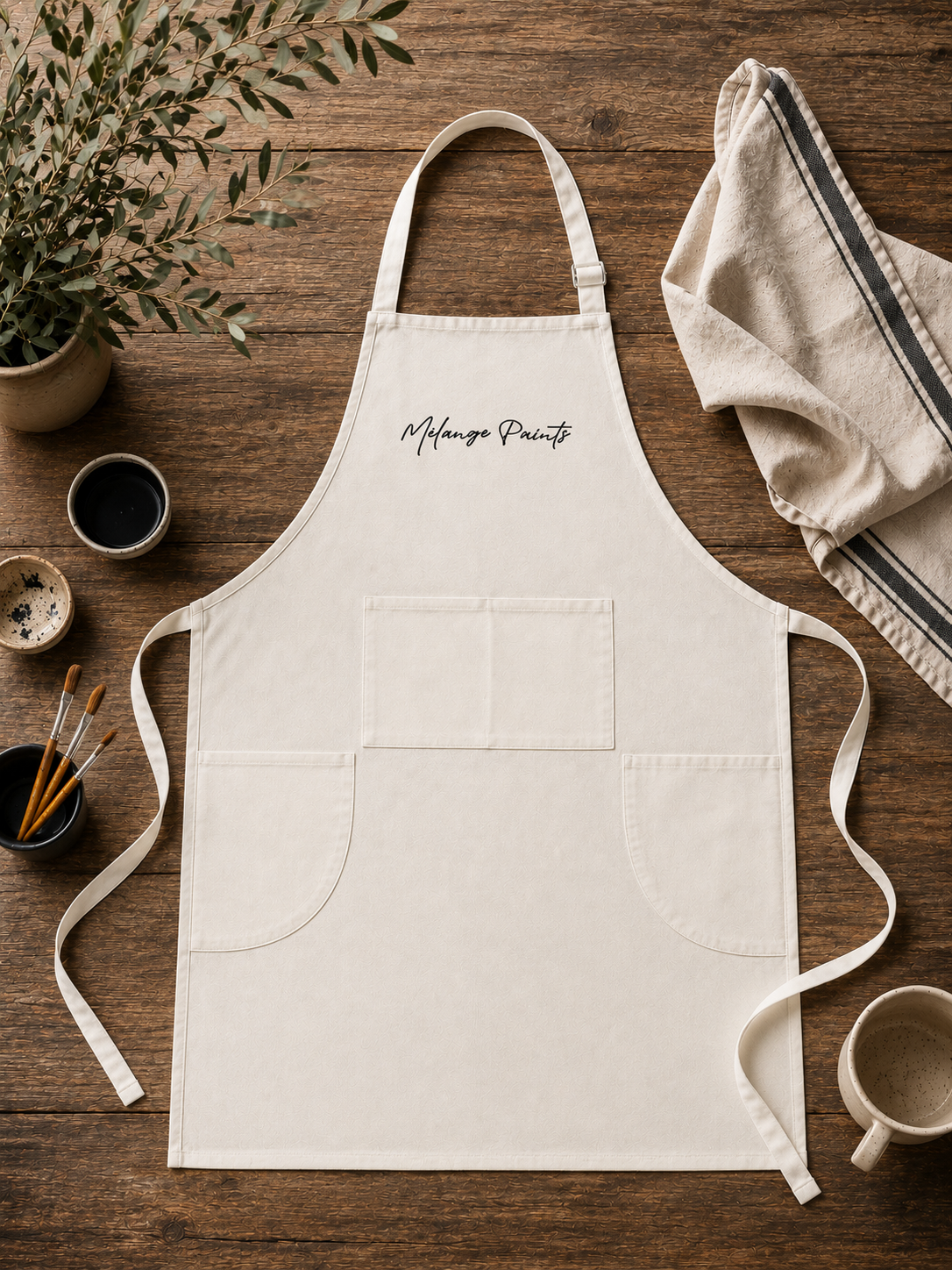 A durable canvas apron designed for painters, makers, and creatives. Features adjustable straps, utility pockets, and full-coverage protection for furniture painting, workshops, and studio projects.
