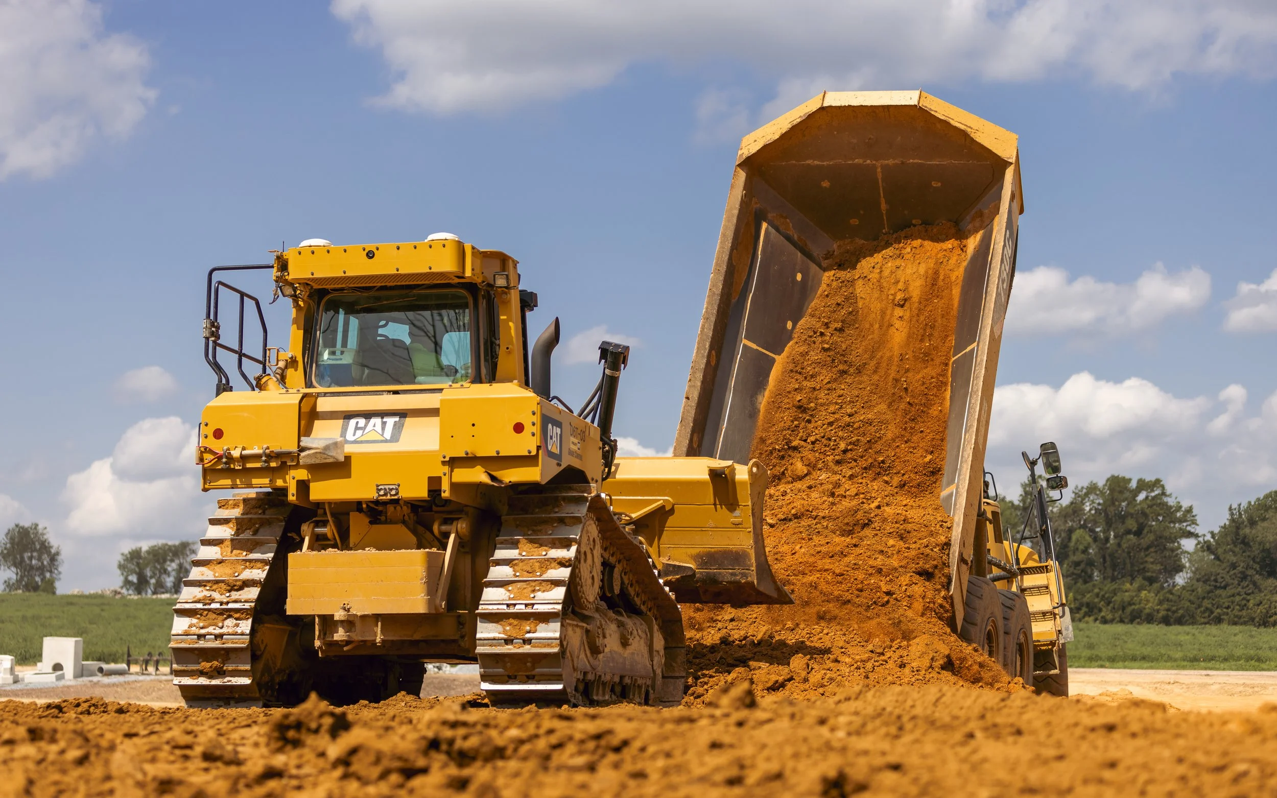 CAT 730 dumping a load of dirt in front of a D6T Dozer at the Brandywine Farms project for Traditions of America