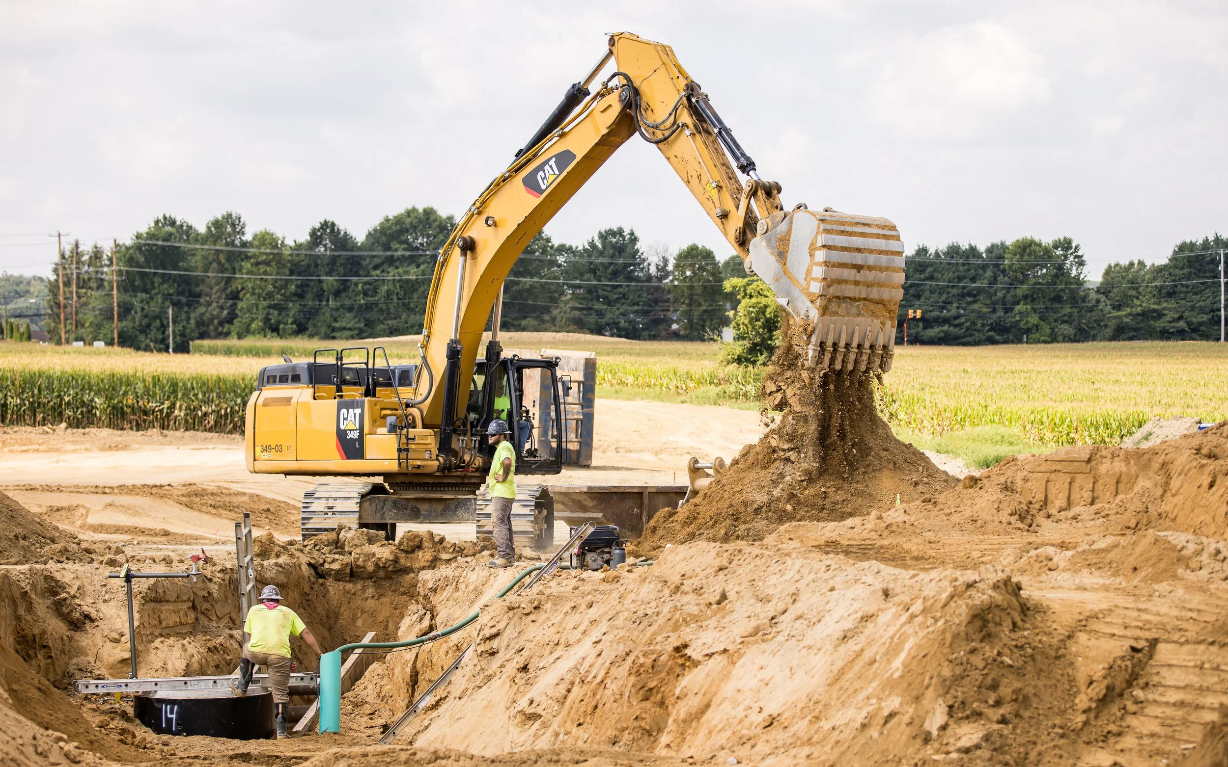 CAT 349 diggin for sanitary sewer pipe at the Brandywine Farms project for Traditions of America