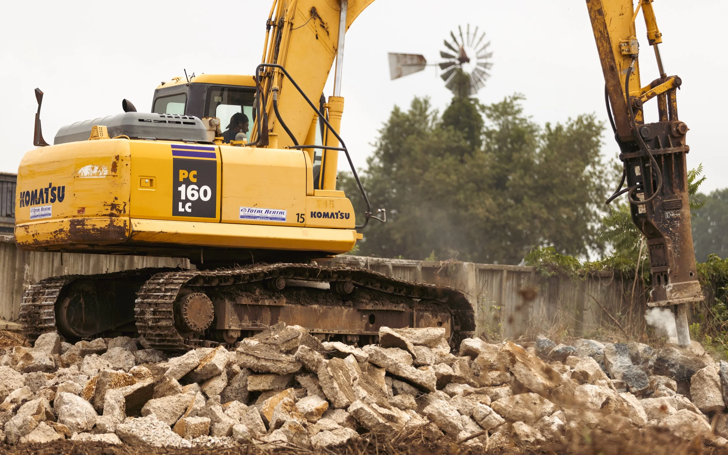 Excavators at work, breaking up concrete pads with precision and power for a demolition project in Chester County. The heavy machinery effortlessly cracks and removes the concrete, paving the way for new construction.