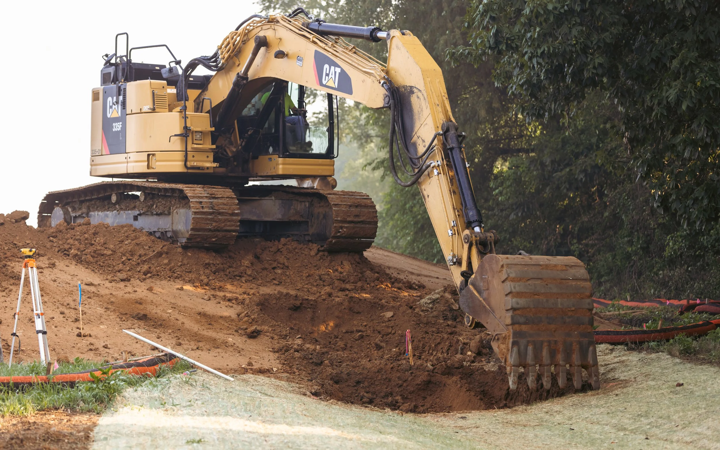 CAT Excavator digging out for a basin outlet at the Brandywine Farms project for Traditions of America
