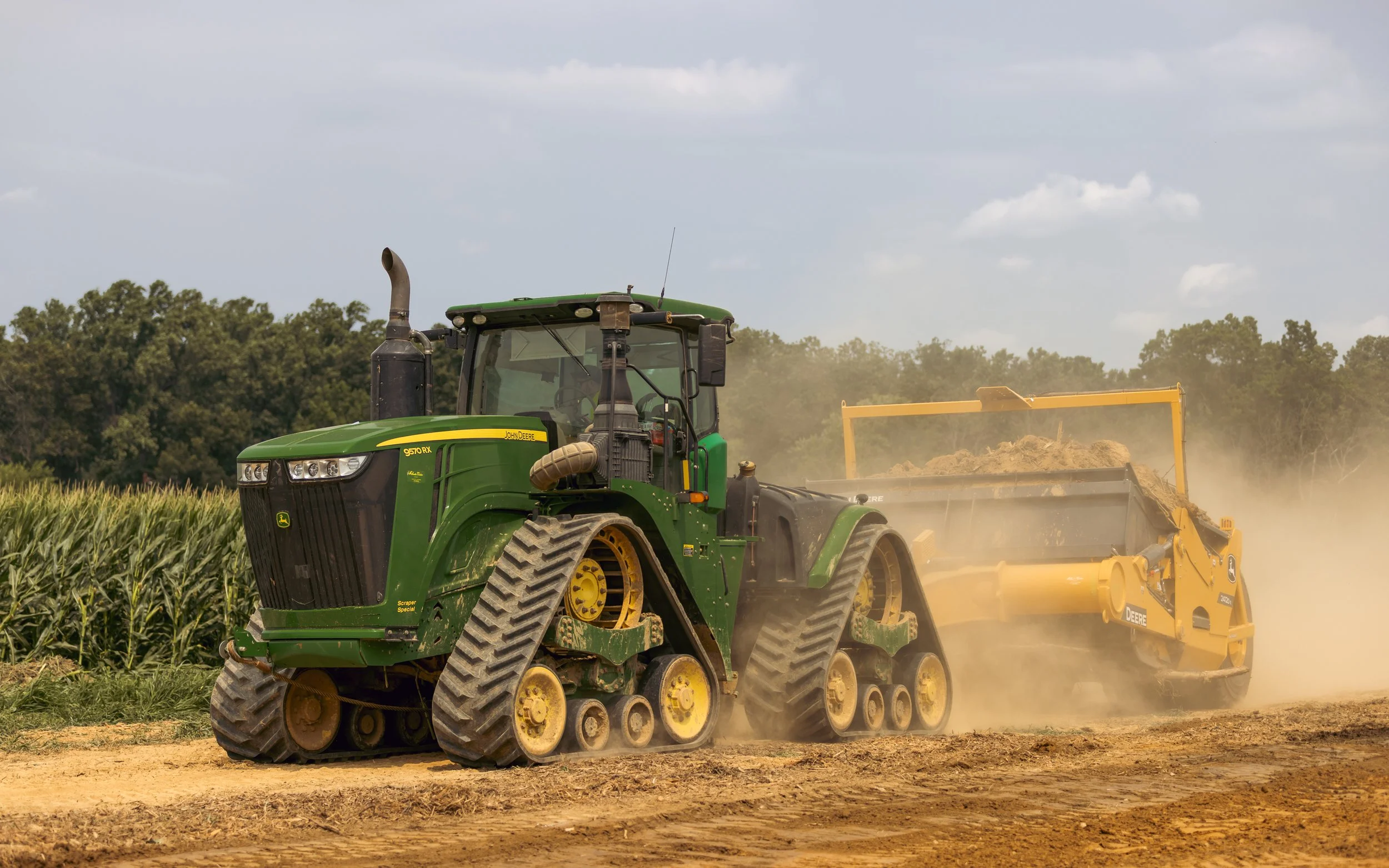 John Deere Tractor Scraper busy stripping topsoil at the Brandywine Farms project.