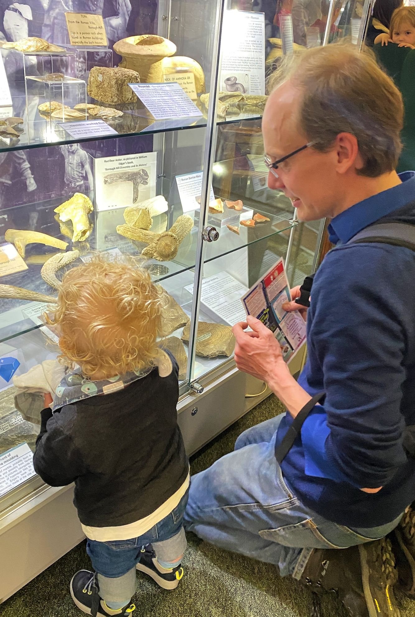Father and son exploring a cabinet