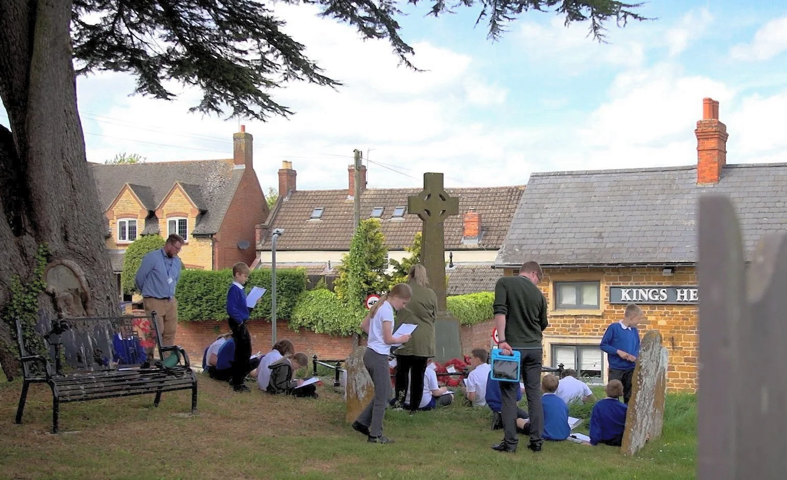 Primary school children working on a WW1 history project at the War Memorial in St Andrew's churchyard in 2022