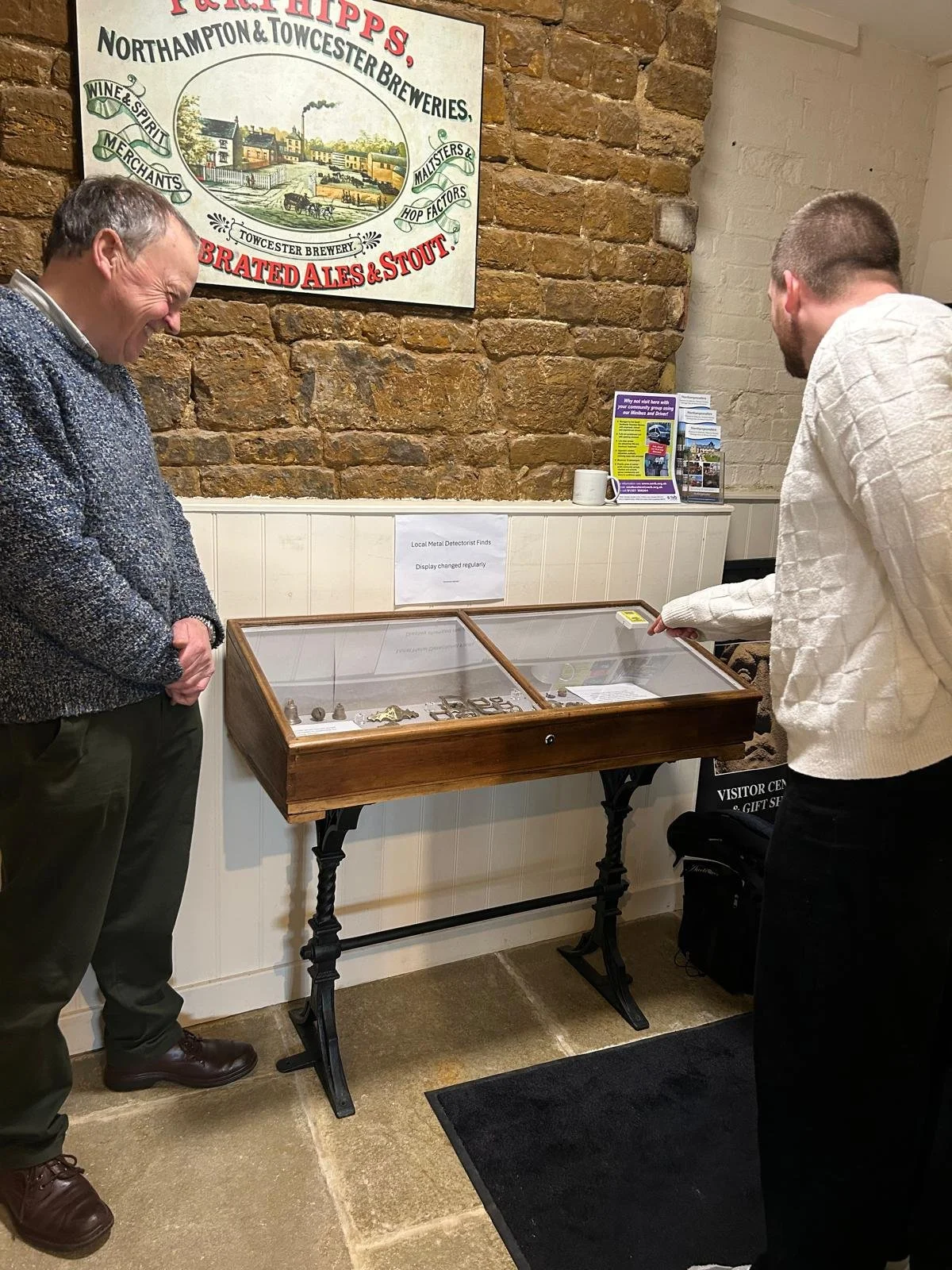 Visitors looking at a cabinet in the museum