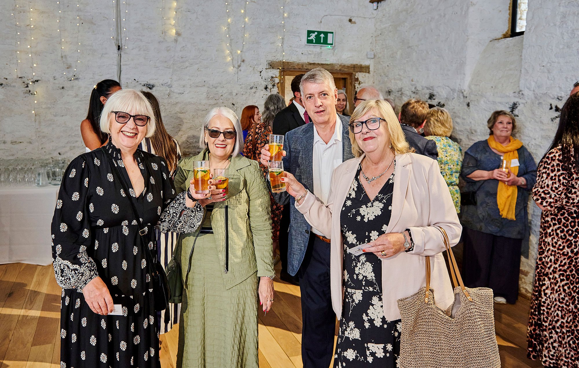 Guests inside the barn enjoying a welcome Pimms
