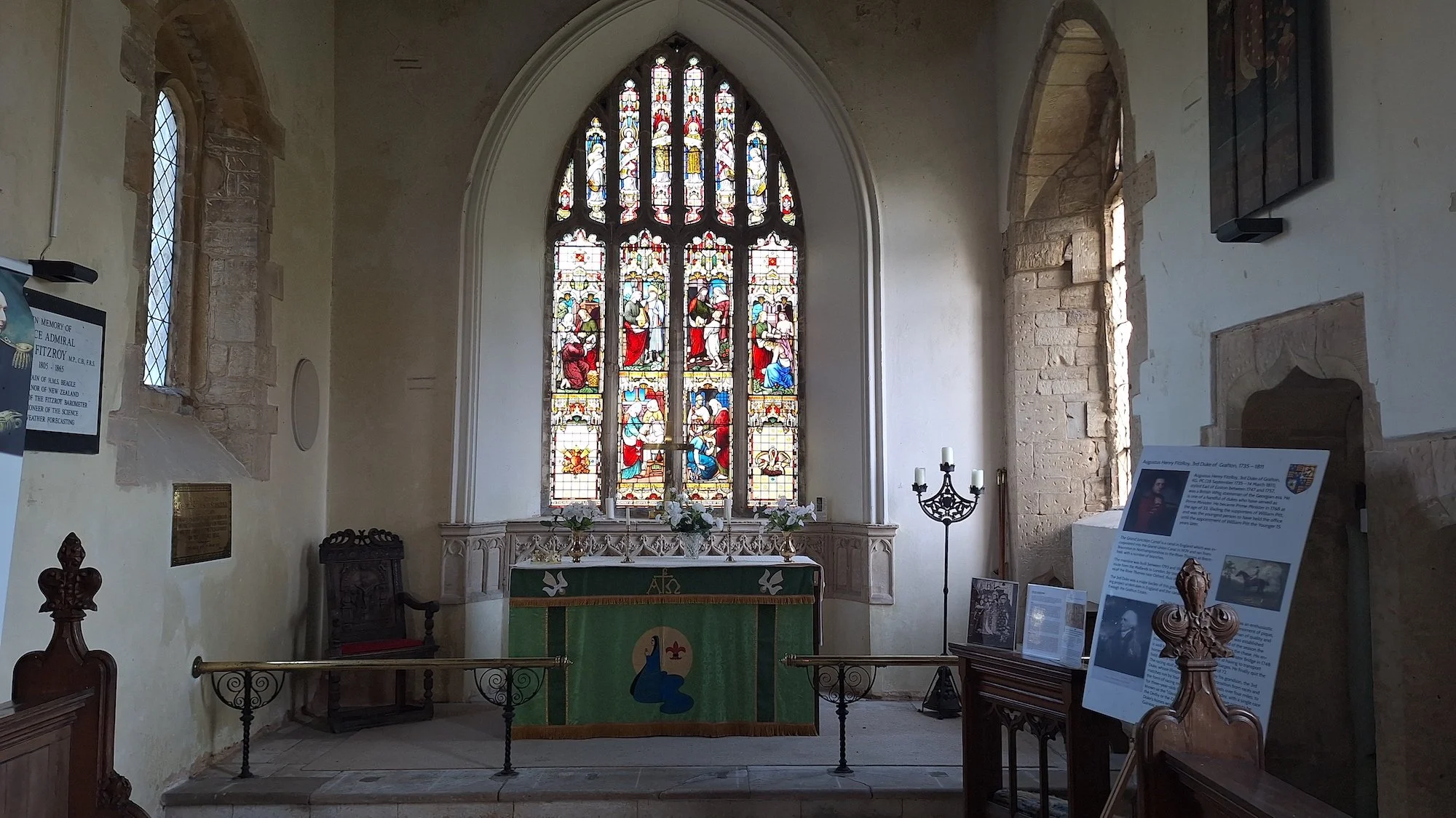 The large stained glass window above the altar