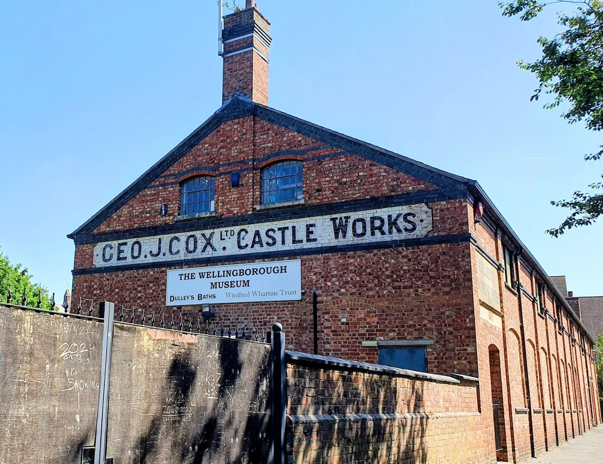 Geo. J. Cox Ltd sign on the side of the museum