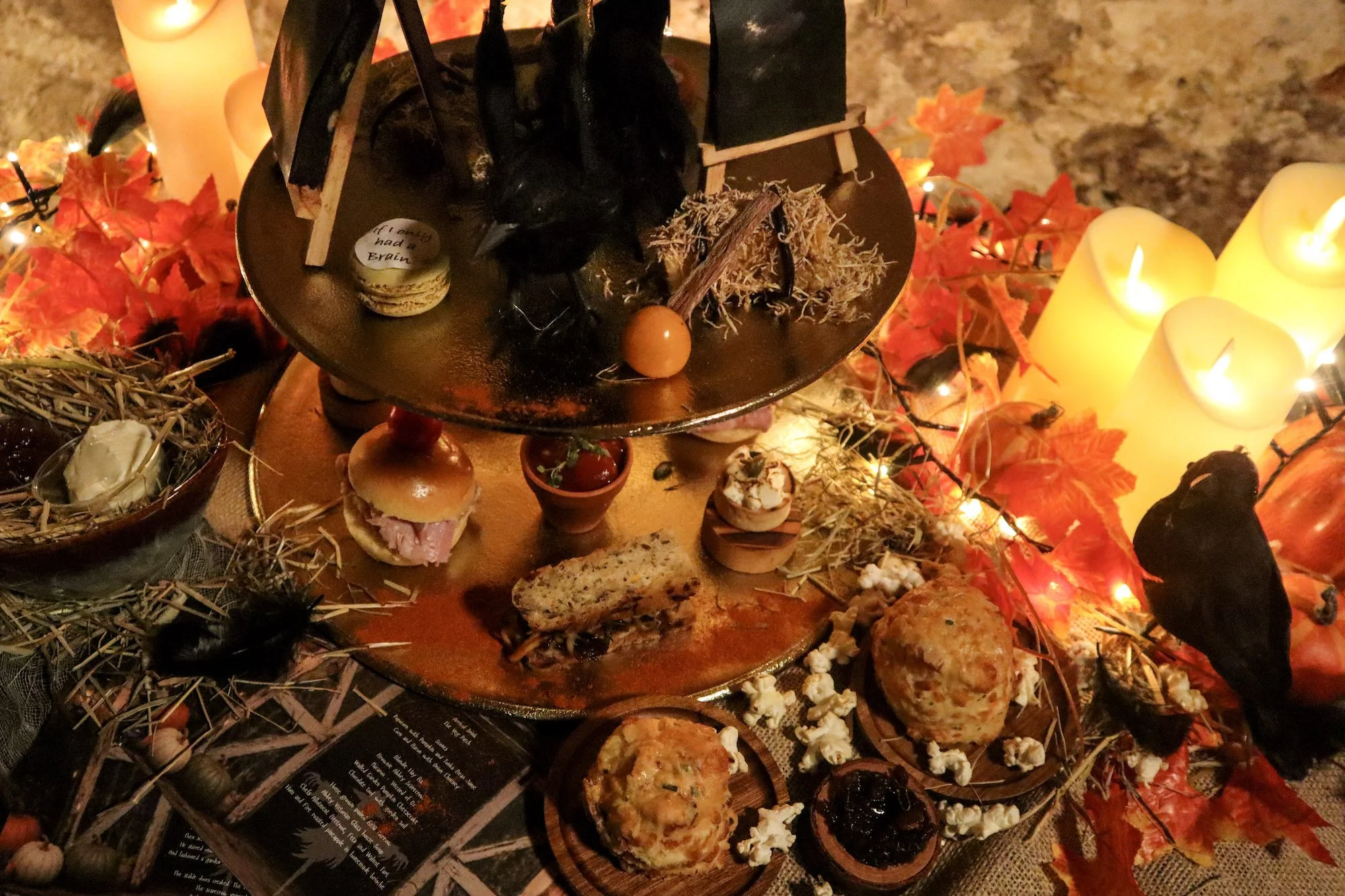 A photo of the spooky afternoon tea with spiders and crows among the decorations on the cake and sandwich stand