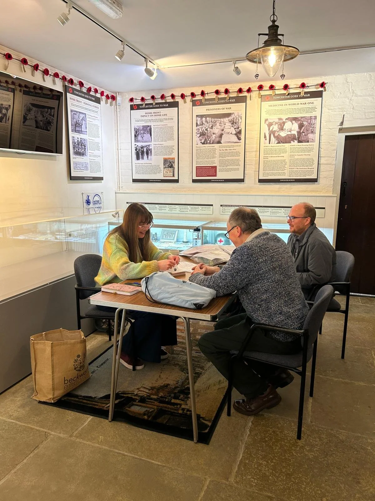 Three visitors at a table in the museum