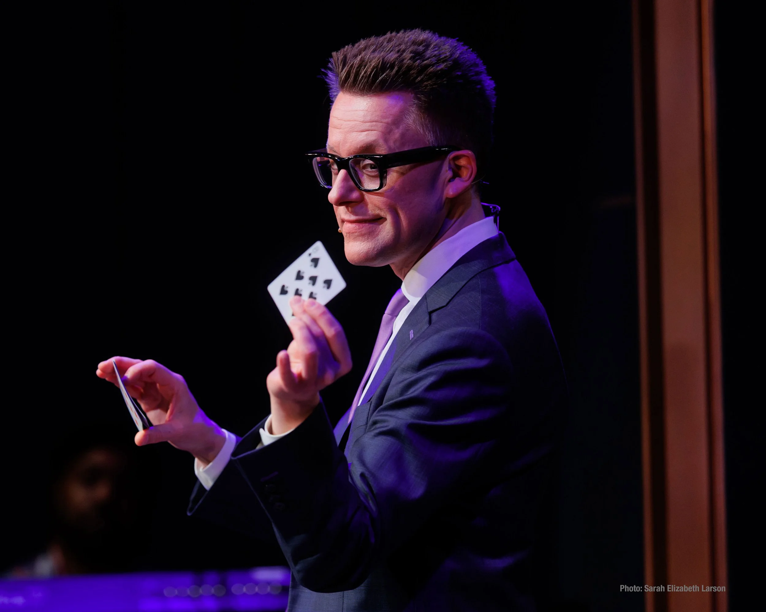 A close-up of Arthur Trace performing a card trick.