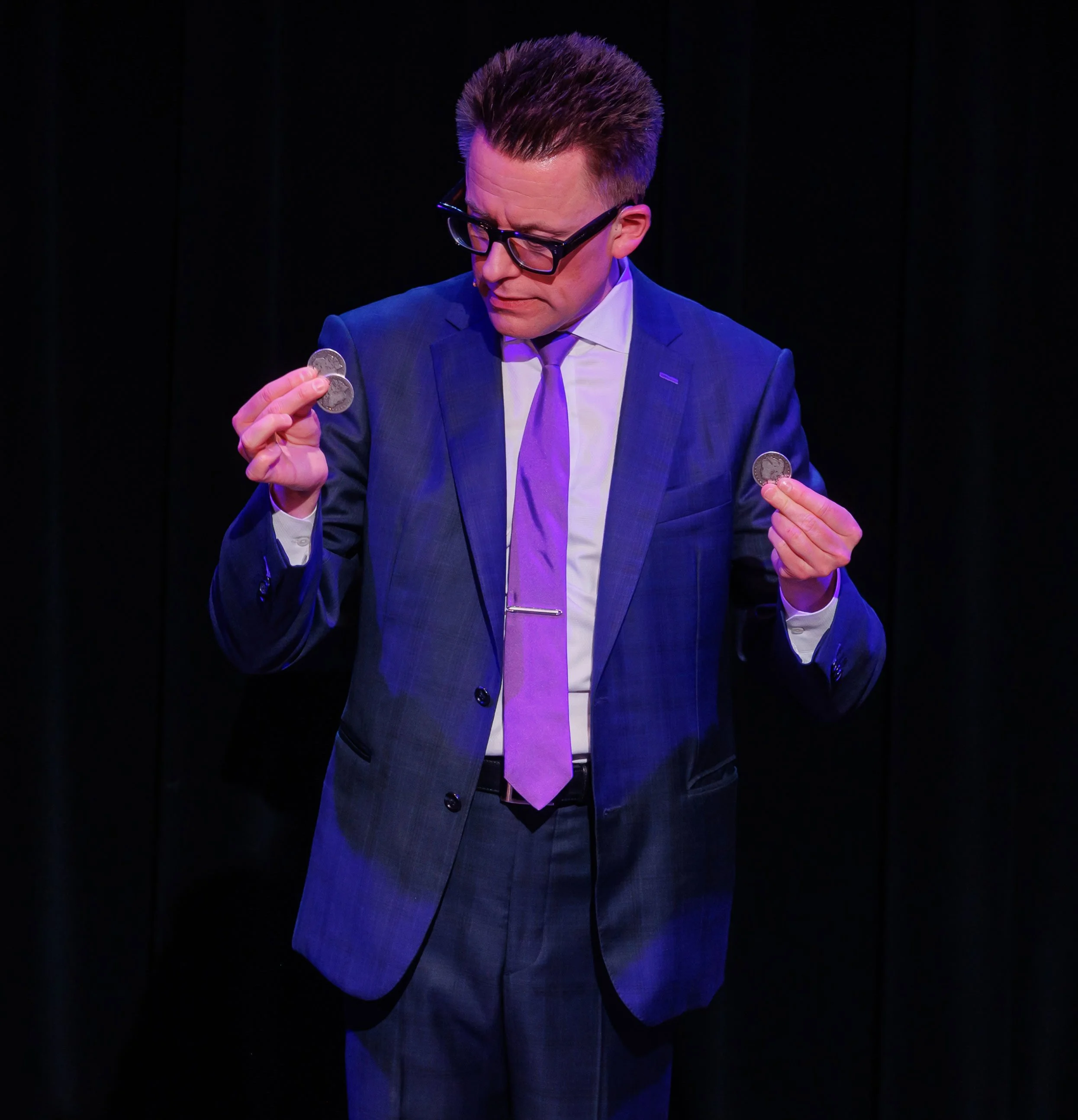 Arthur Trace performing close-up coin magic for event guests