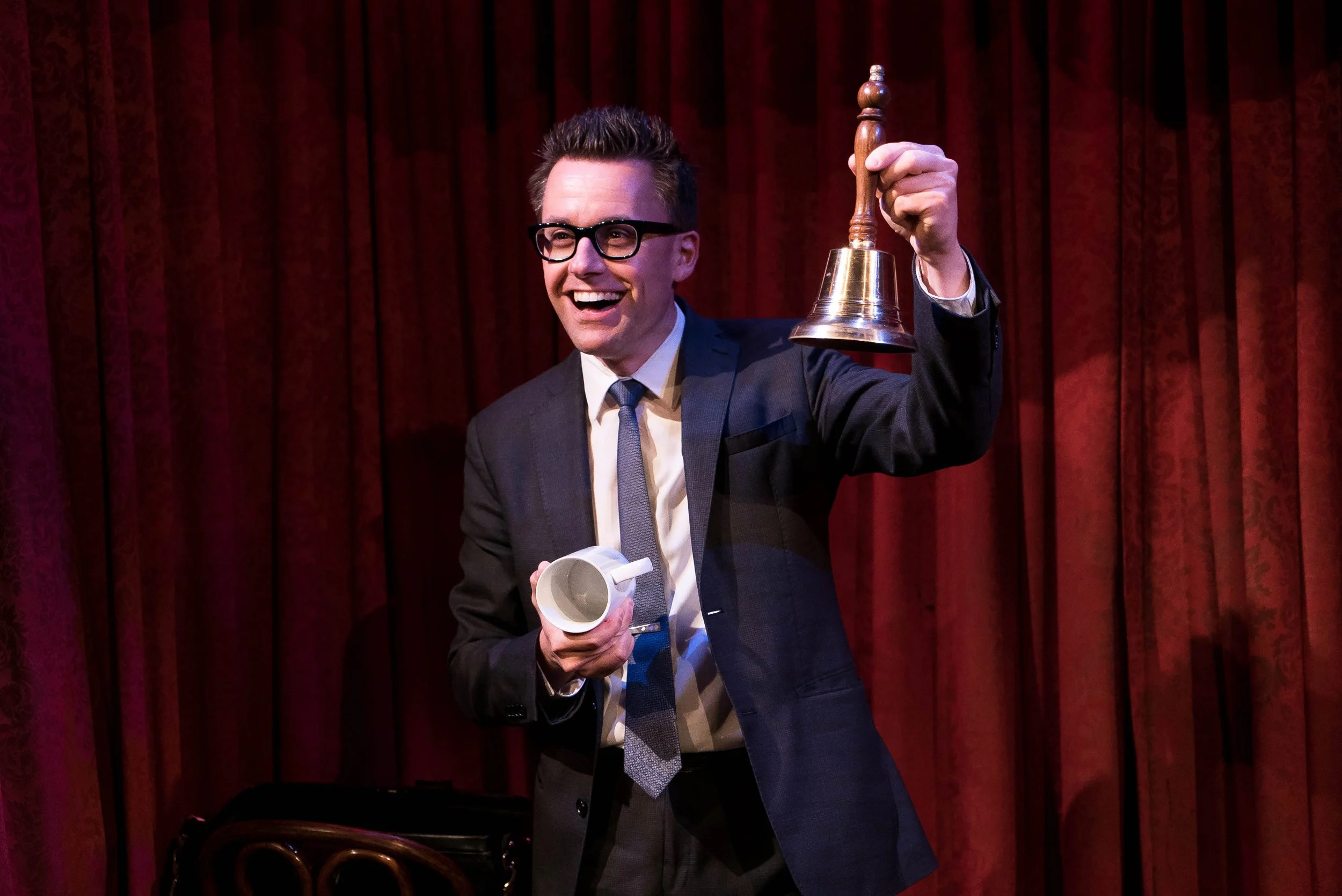 Arthur Trace performing a routine with a bell at The Magic Castle's Parlour of Mystery Theater.