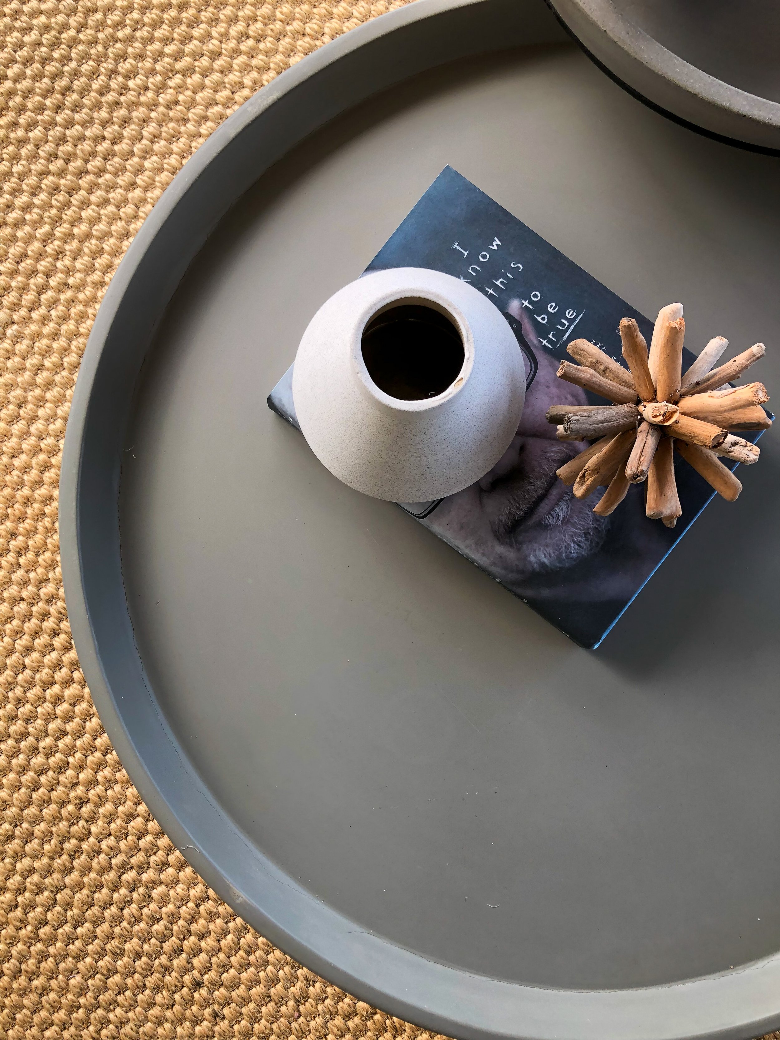 Home staging with rattan rug and charcoal tables