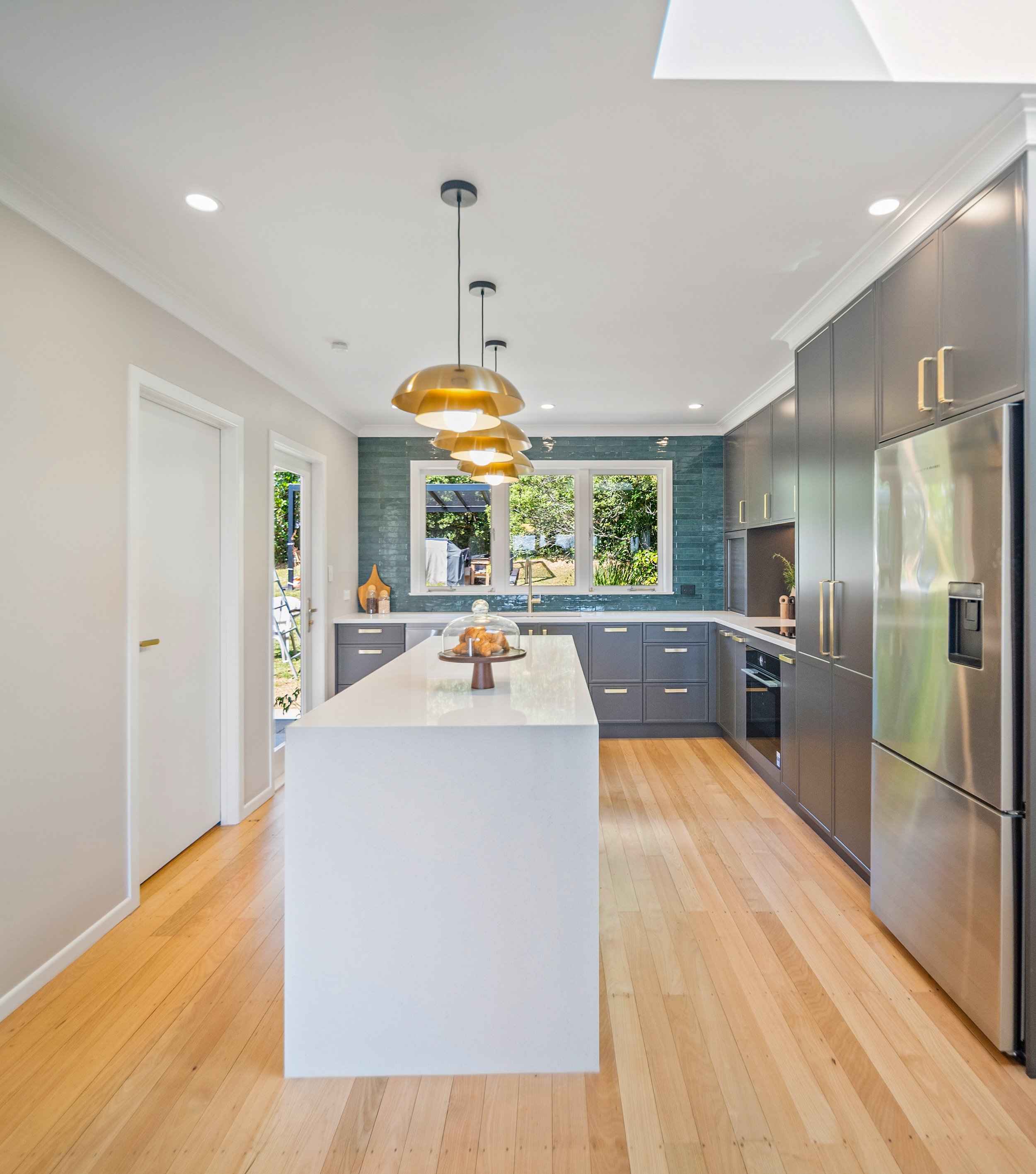 Narrow kitchen - grey, teal and gold