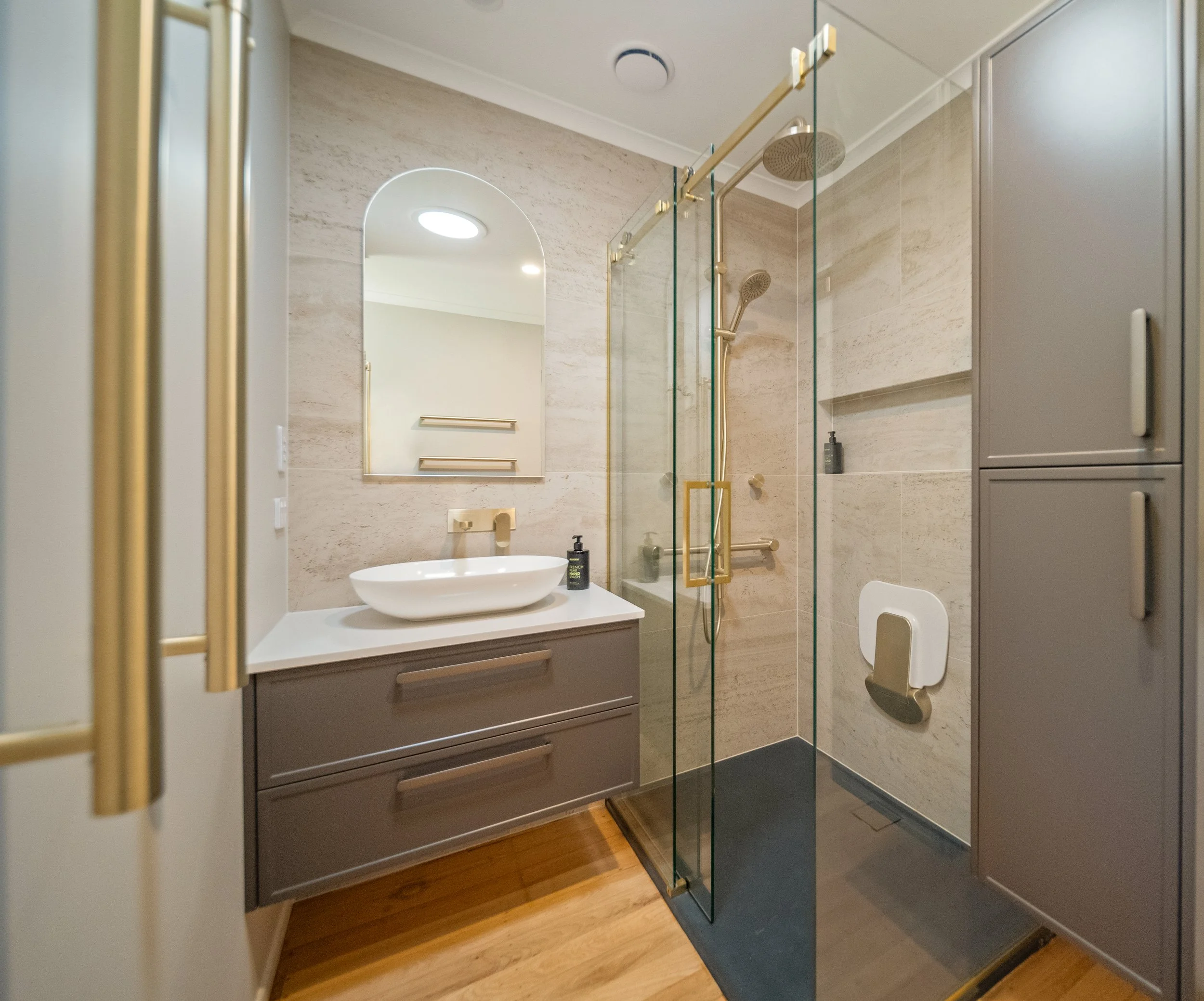 Grey and gold bathroom . North shore renovation.