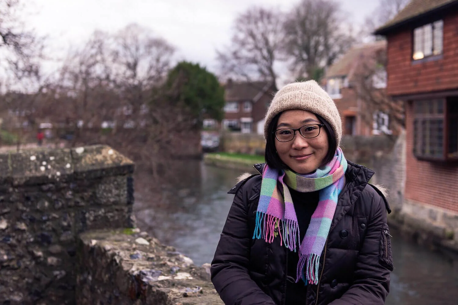 Japanese woman looking into the camera by a river