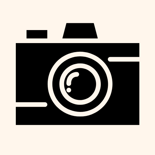 Icon of a black and white camera with a lens, flash, and viewfinder, on a beige background.