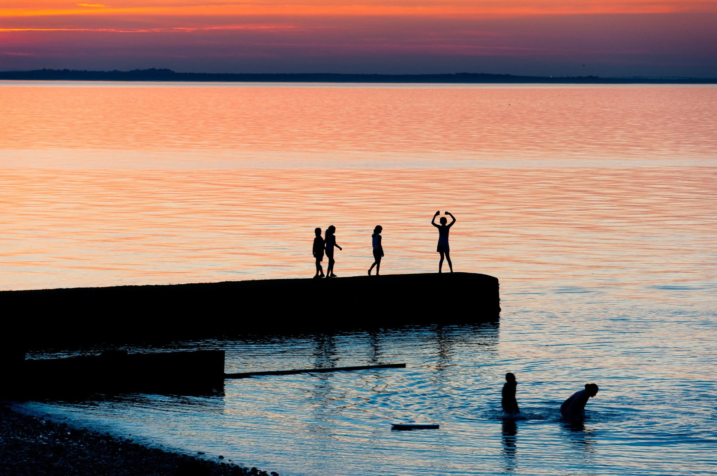 Photograph of family playing on the beach