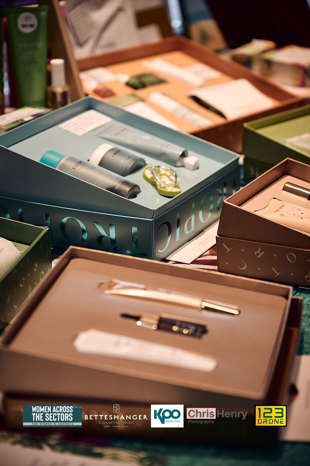 Display of skincare and beauty products in colorful boxes at a store or exhibition.