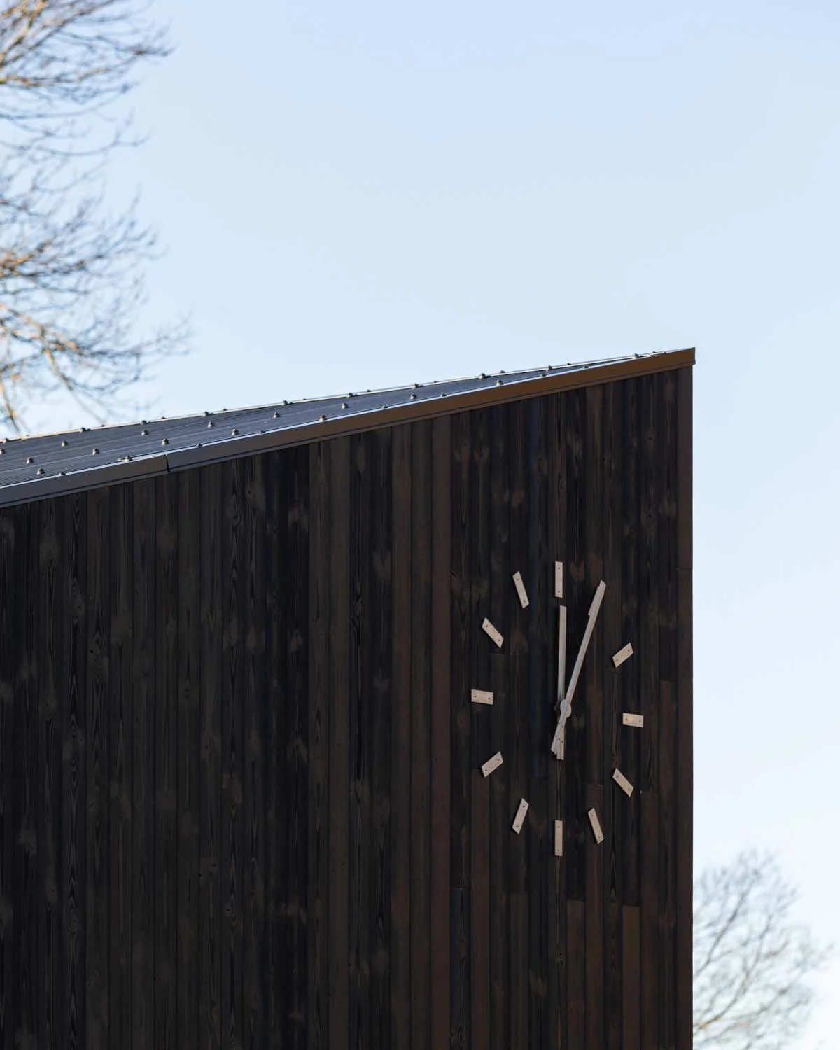 Site progress, December 2025. Shou Sugi Ban cladding, corrugated roofing, and new public clock © Rachel Ferriman.